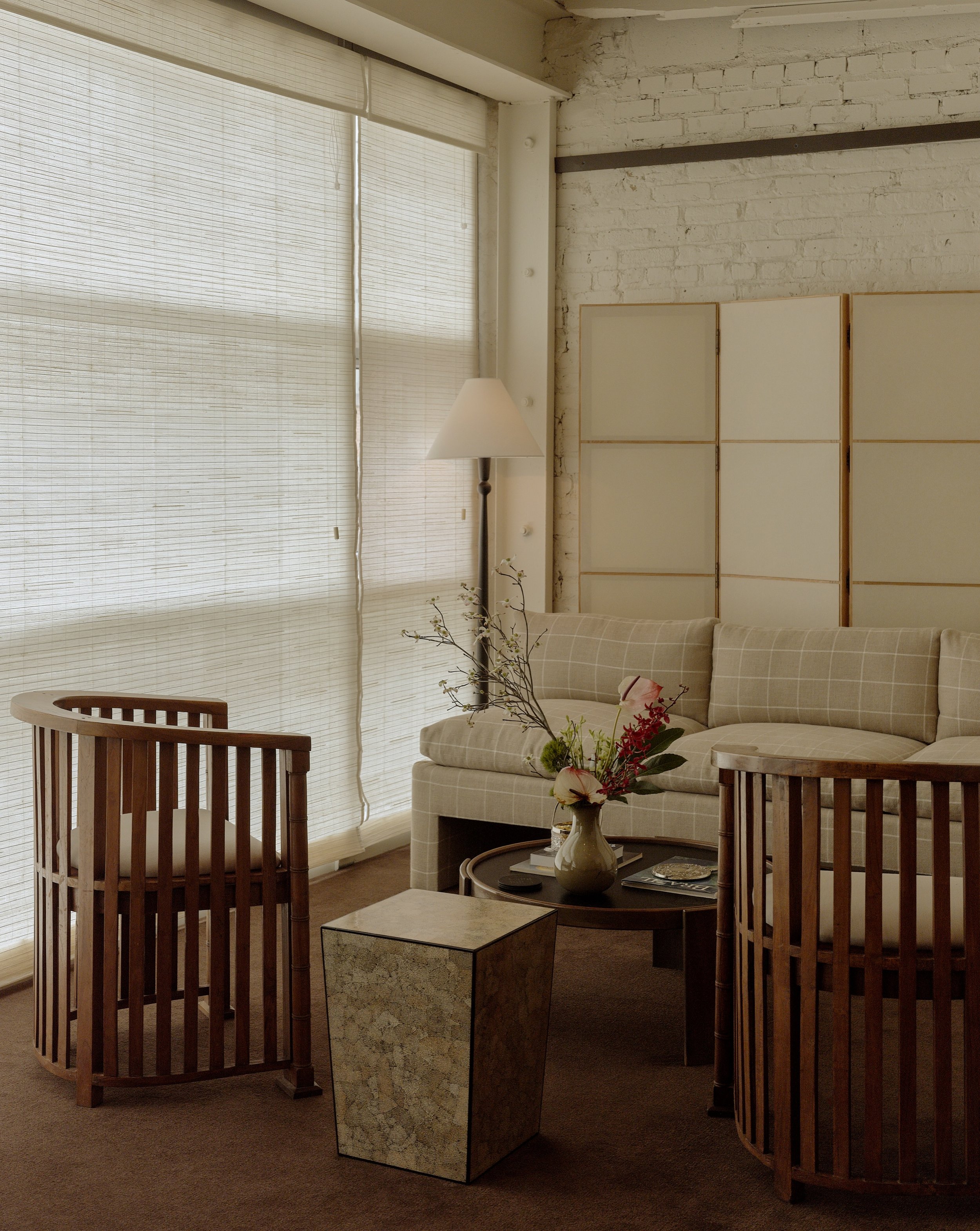 One side of the main lounge at @spencers.spa Williamsburg. A curated mix of special vintage pieces, each with its own history and character.

A 1960s armless slipper sofa with goose-down cushions, custom reupholstered in a classic @schumacher1889 lin