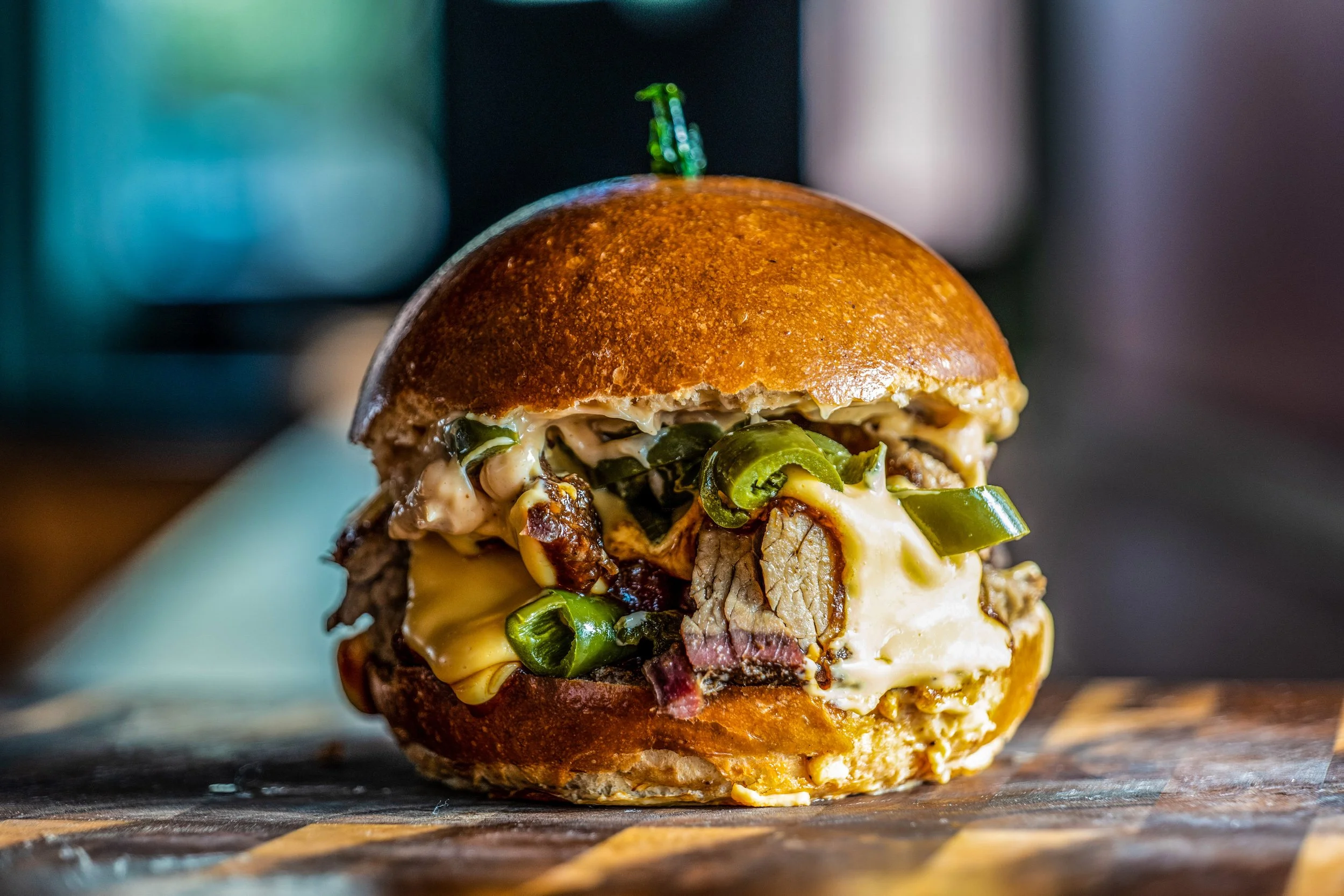 Jalepeno brisket burger with melty cheddar, house made bbq, smoked jalepeno, and a chipotle aioli for lunch and event catering