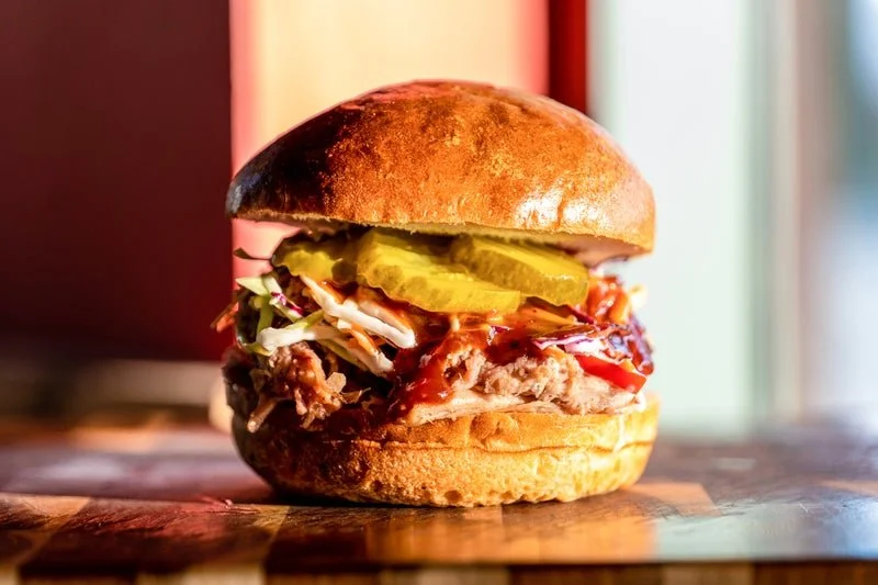 Pulled pork with house slaw and home made pickles for catering and lunch delivery catering