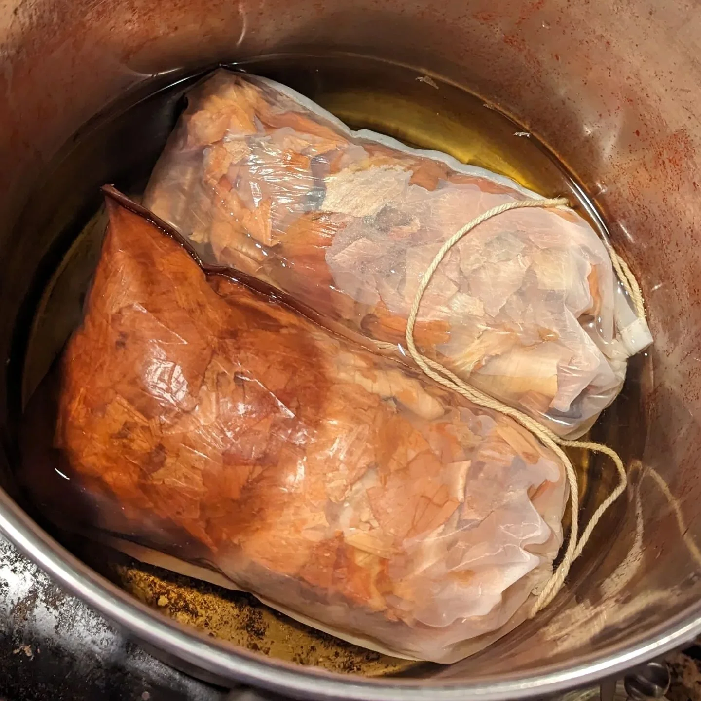 Several months of onion peel shavings stuffed into mesh bags and hit water for another new dye.