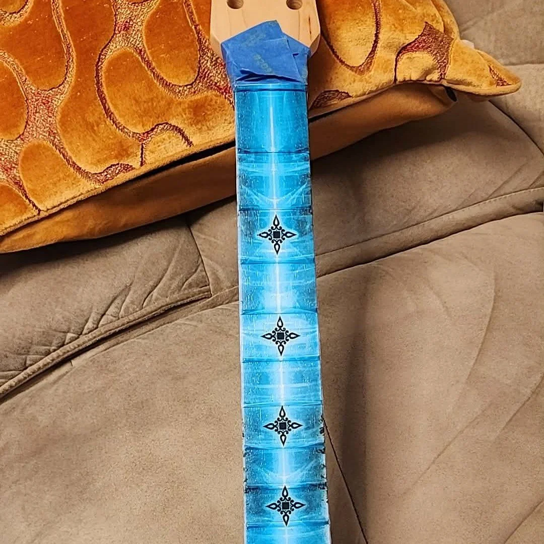 Not sure if any one else has tried it but we printed on a guitar neck using the Eufy resin printer. It had to be printed in 2 passes but it looks cool. I know it will probably wear off. Any ideas about how I can protect the art while its being played