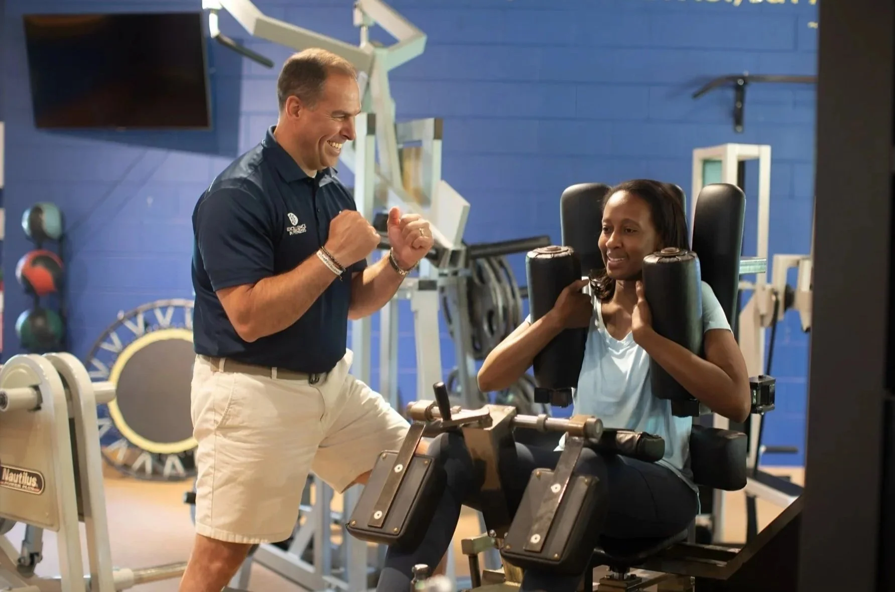 Personal trainer coaching a client during a one-on-one strength training session at Excellence In Fitness in Annapolis, Maryland.