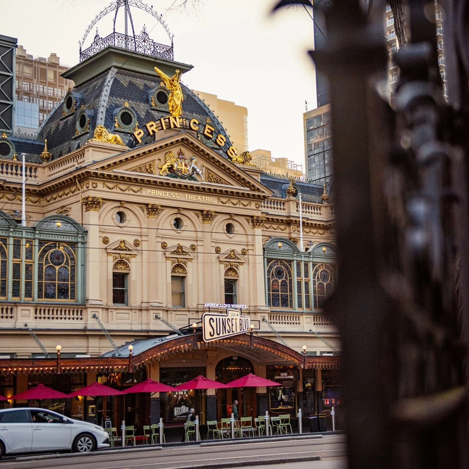 Aerial view of the iconic XXXX Brewery in Milton, Brisbane. The large red-brick industrial building features the “Milton Brewery” signage, a cartoon character holding a beer, and prominent XXXX branding on the rooftop and beer tanks.