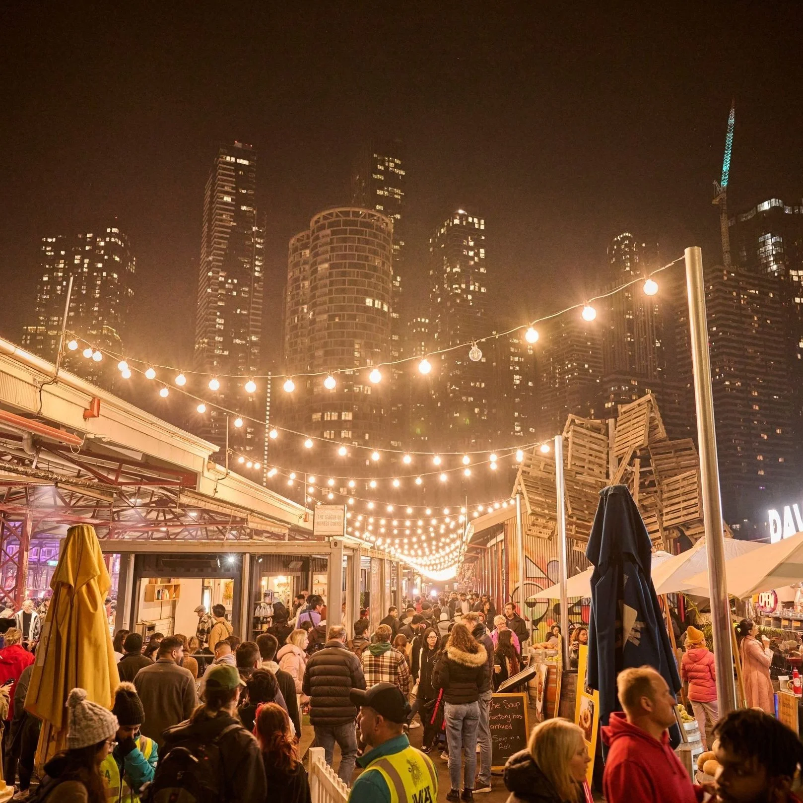 Aerial view of the iconic XXXX Brewery in Milton, Brisbane. The large red-brick industrial building features the “Milton Brewery” signage, a cartoon character holding a beer, and prominent XXXX branding on the rooftop and beer tanks.