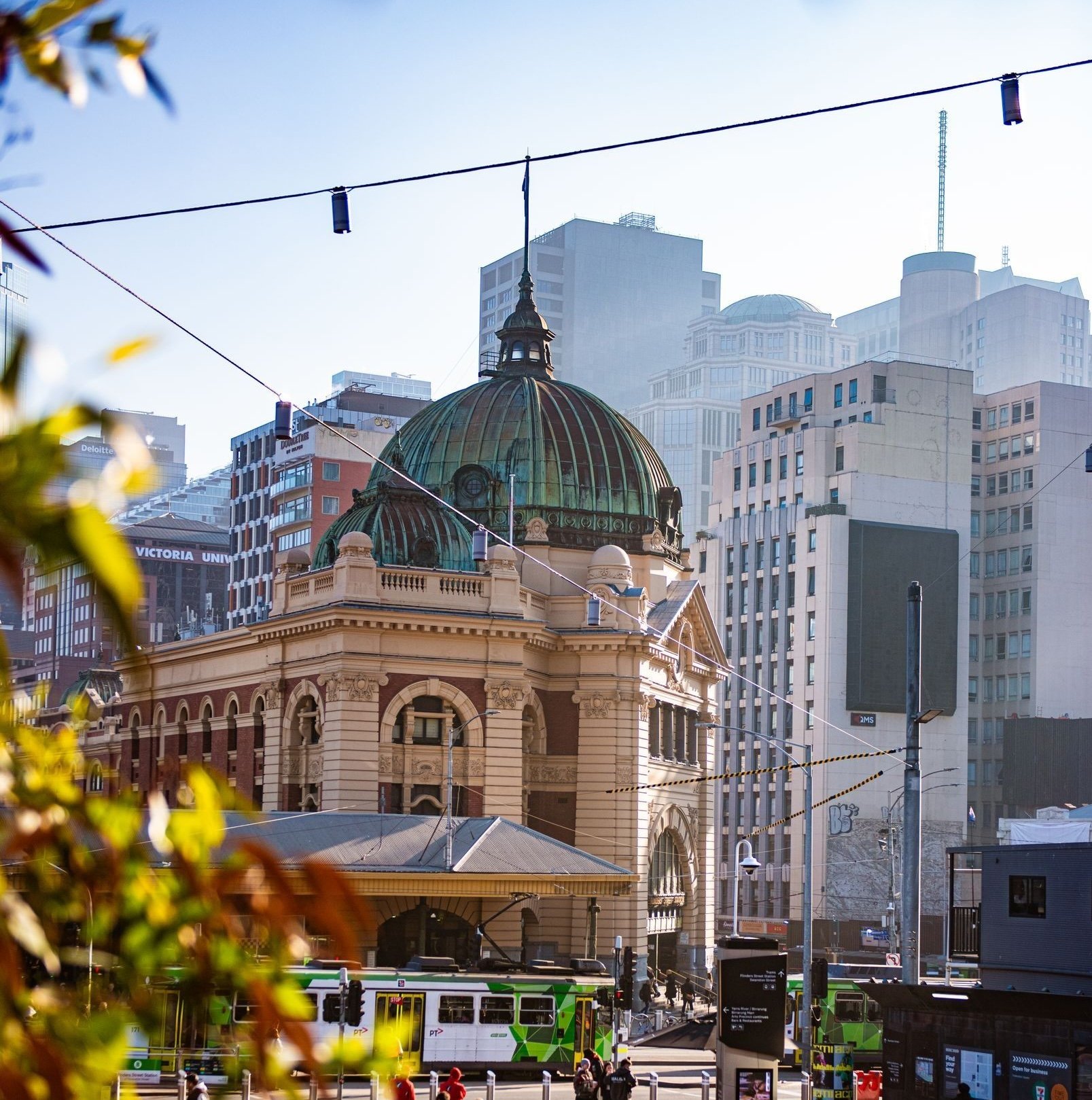 Aerial view of the iconic XXXX Brewery in Milton, Brisbane. The large red-brick industrial building features the “Milton Brewery” signage, a cartoon character holding a beer, and prominent XXXX branding on the rooftop and beer tanks.