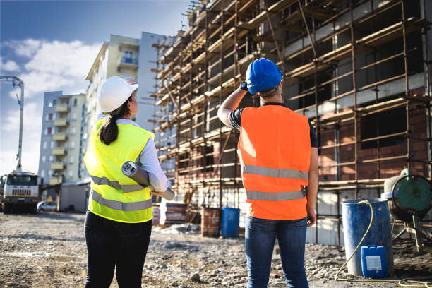 2 workers from behind on site.jpeg