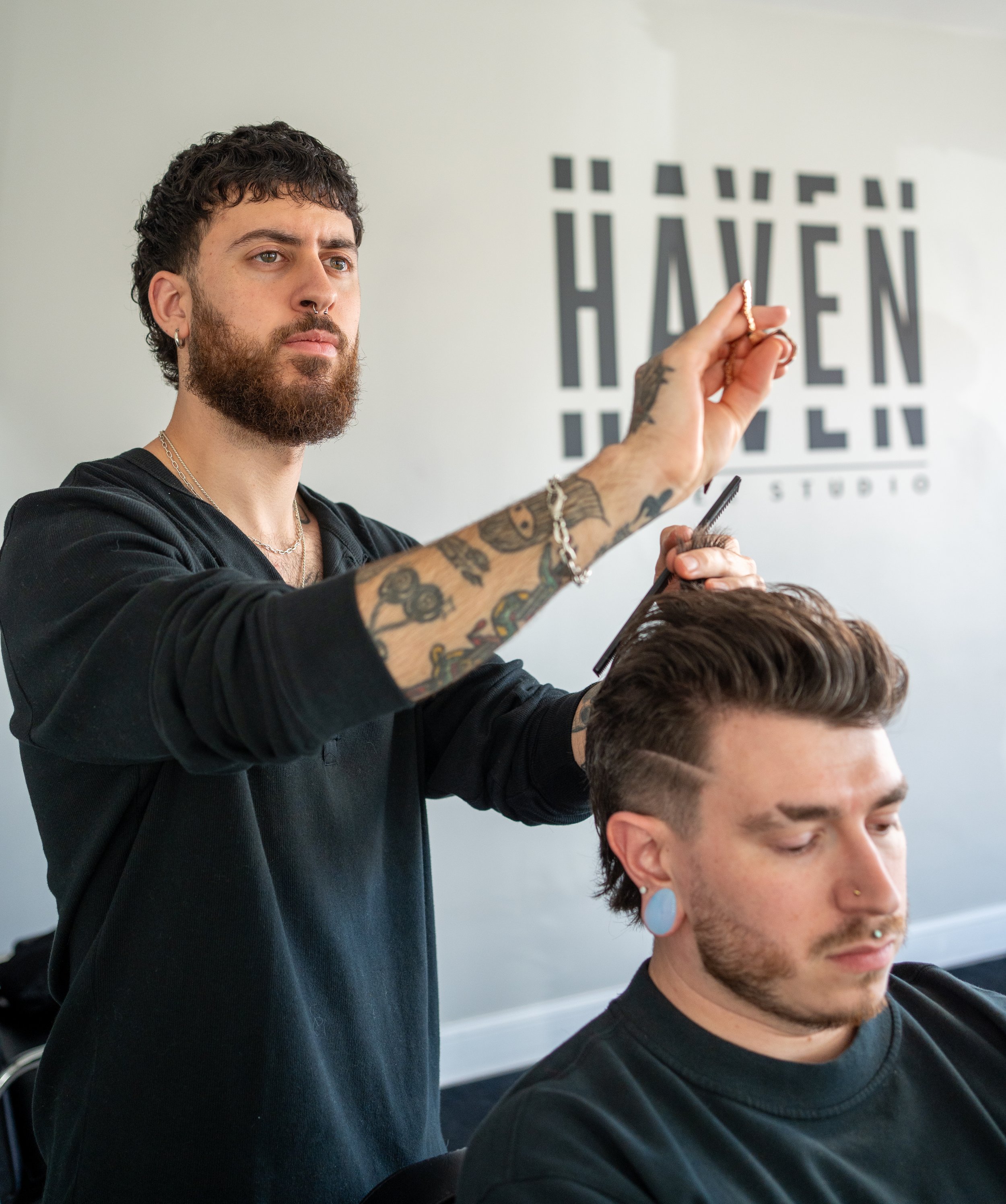 Haven barber Dom scissor cutting a client's hair at Haven Barber Studio in Wilmington, MA