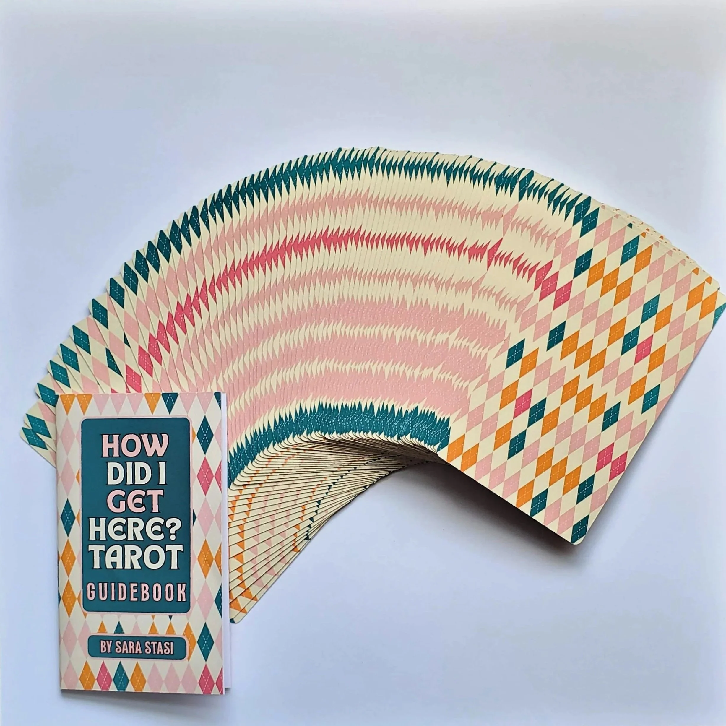 How Did I Get Here Tarot cards fanned showing diamond pattern card backs and guidebook — pop art collage indie tarot deck by S.G. Stasi Designs