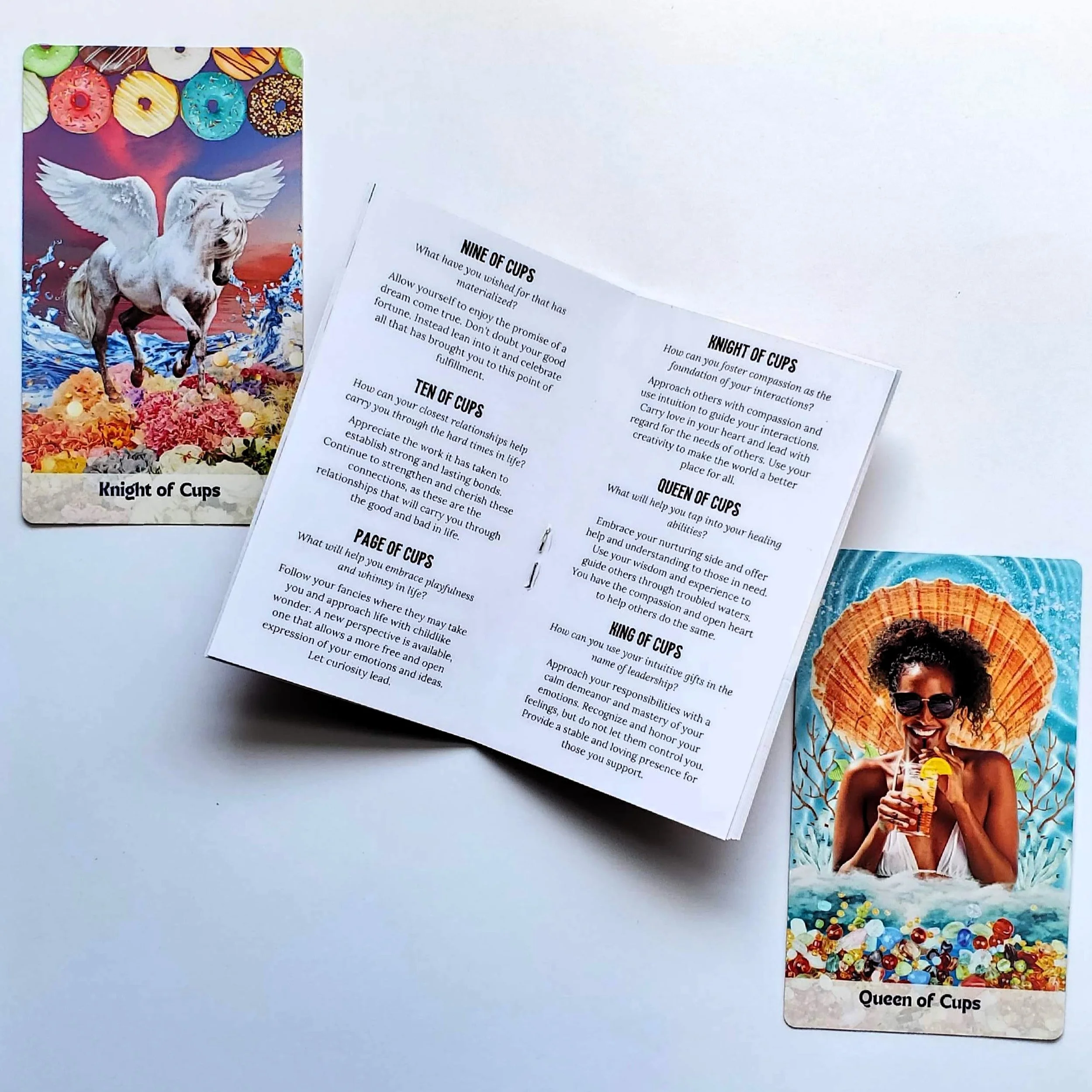 How Did I Get Here Tarot guidebook open showing card interpretations — pop art collage indie tarot deck by S.G. Stasi Designs