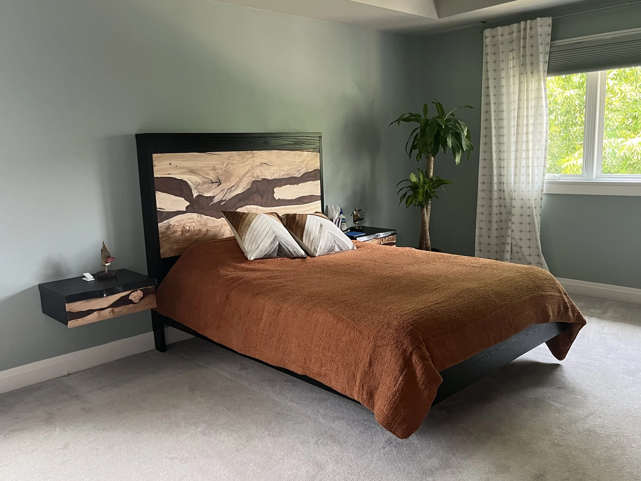 Floating platform bed and night stands made from stained black oak and maple with copper colored resin. 