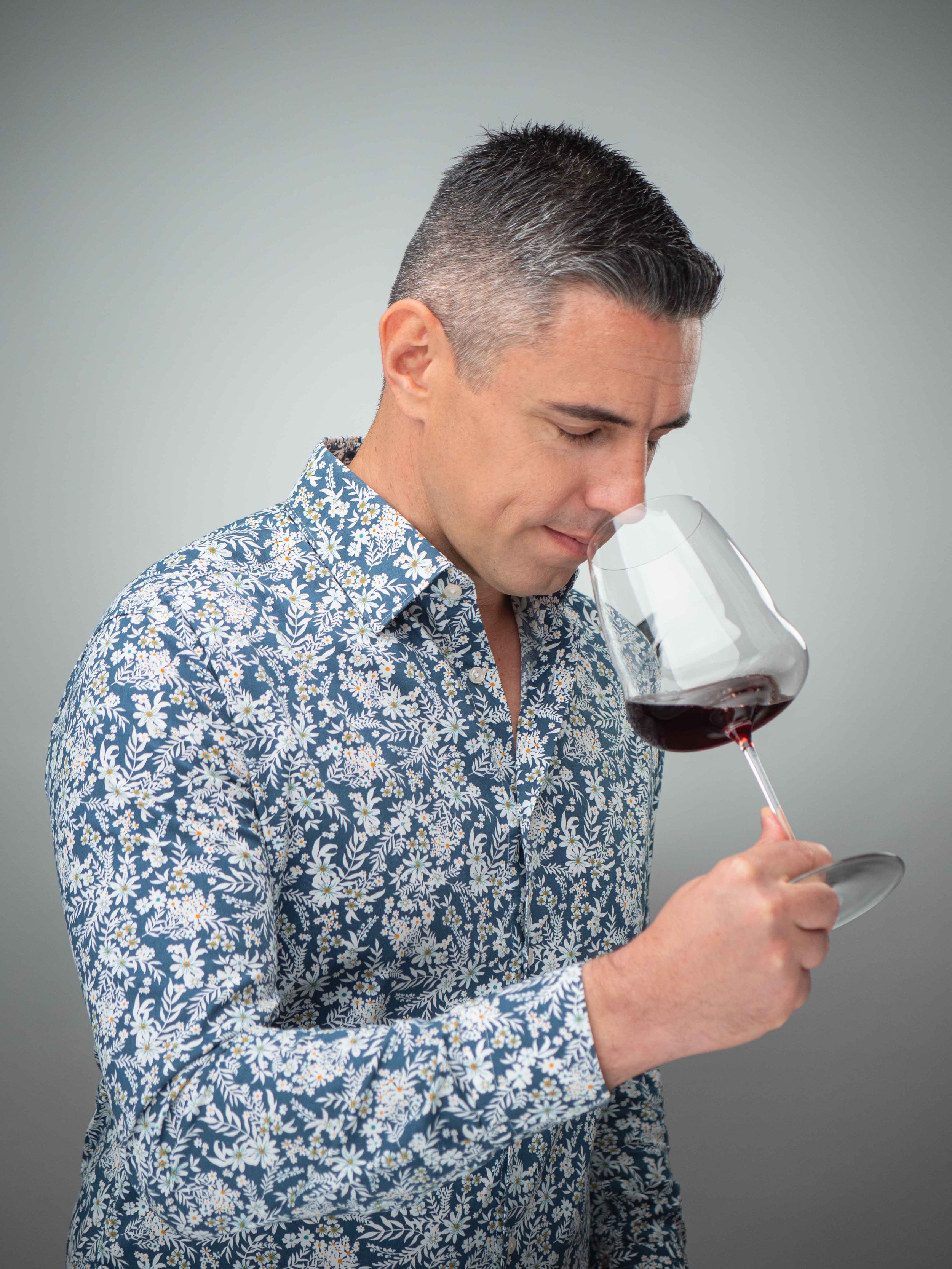 corporate headshot in Singapore of Loic Brachet with red wine, during a professional photo shoot at a photo studio near you