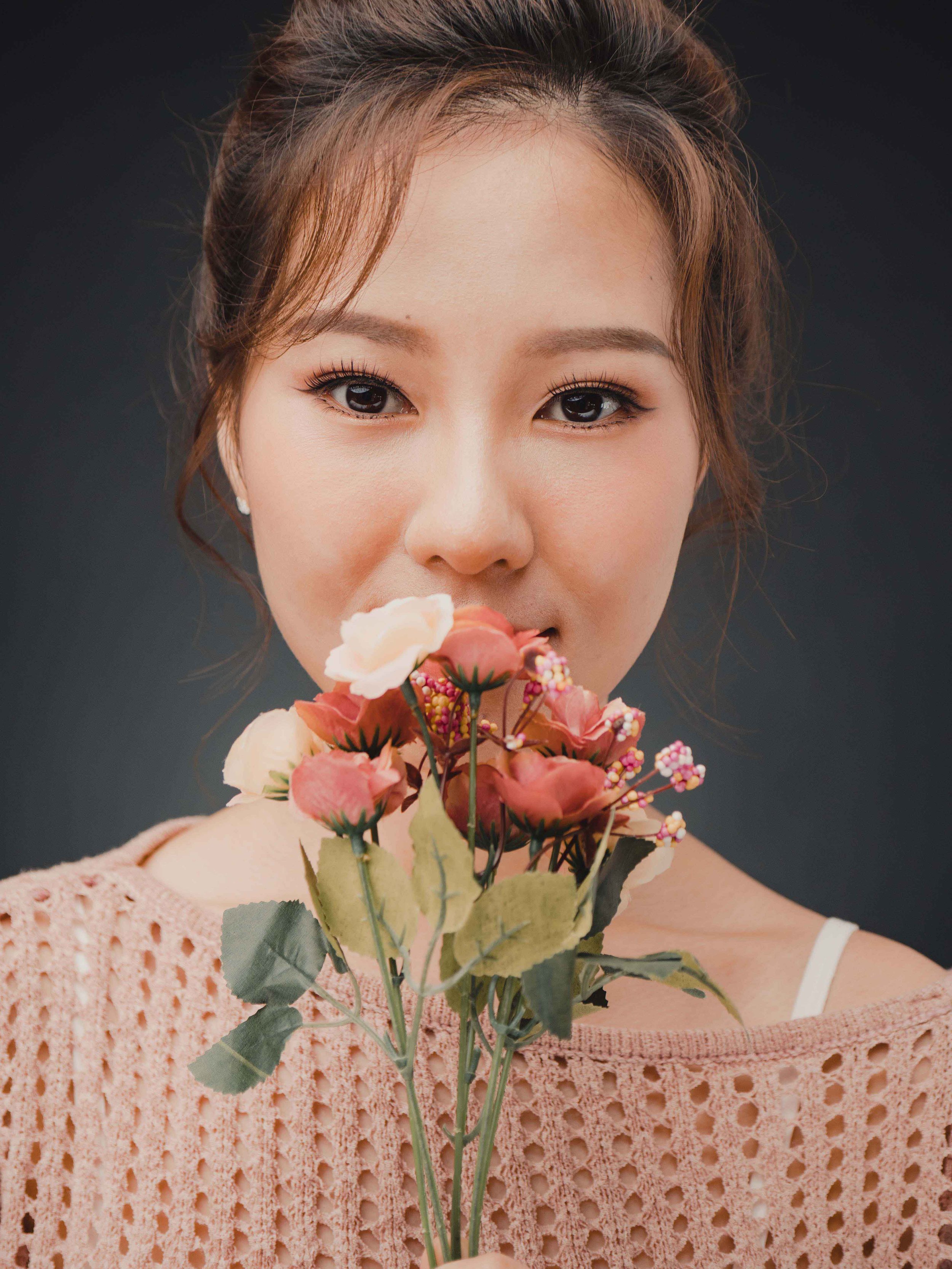 chinese style photo shoot with flower prop in Singapore, during a professional photo shoot at a photo studio near you