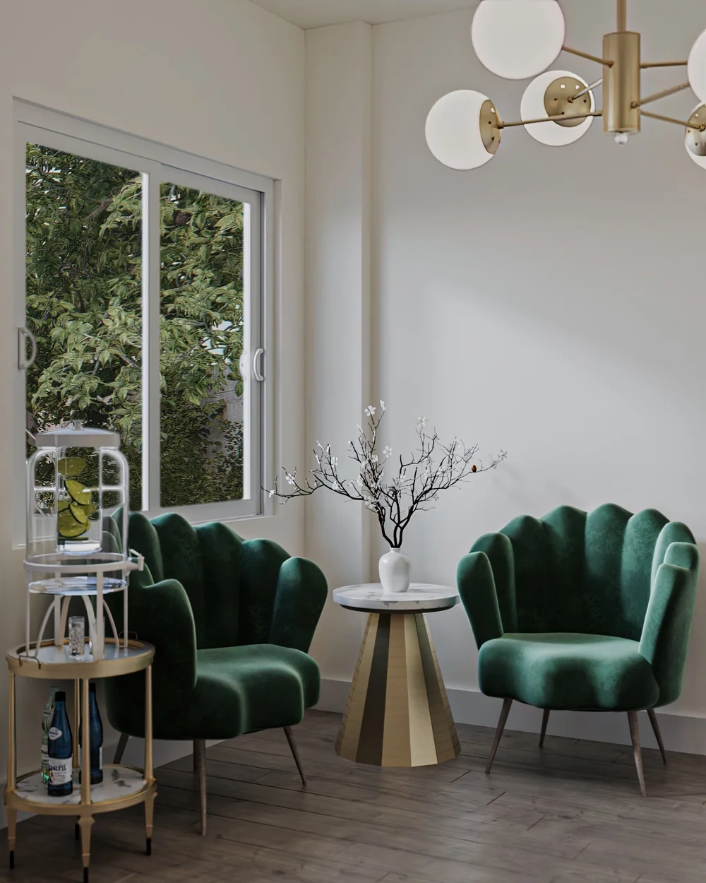 A sitting area with green velvet chairs and a globe chandelier