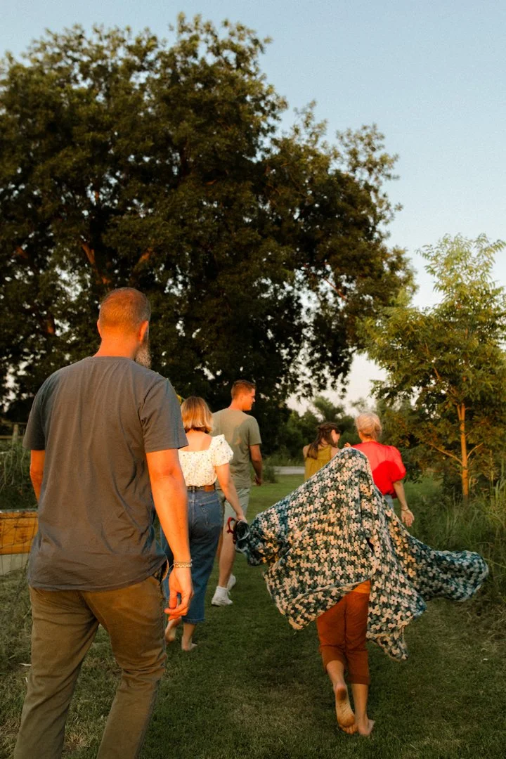  family running with blanket behind them 
