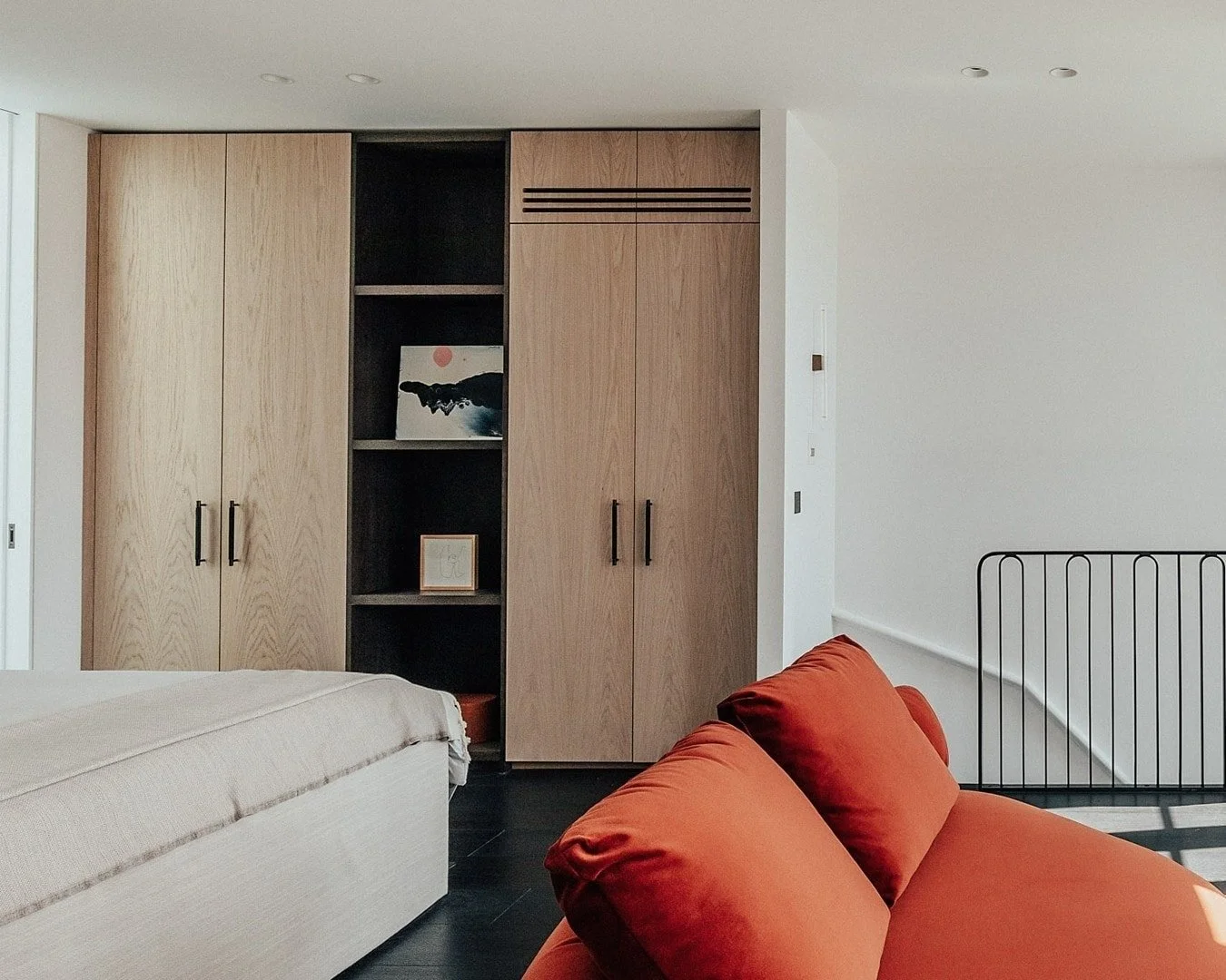 A home designed to adapt to the way life is truly lived.

In the master bedroom, natural oak meets rich espresso accents, with LED-lit shelving casting a soft evening glow and wardrobes that light up quietly as the doors open. The result is a space t