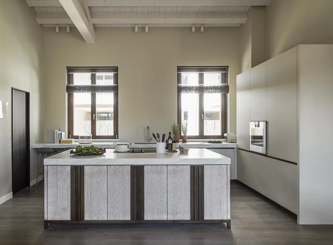 This kitchen is filled with soft morning light, setting a calm tone for the day. Painted in Farrow &amp; Ball&rsquo;s Old White, the cabinetry adds a soft, timeless feel that ties everything together. The island naturally becomes the centre of it all