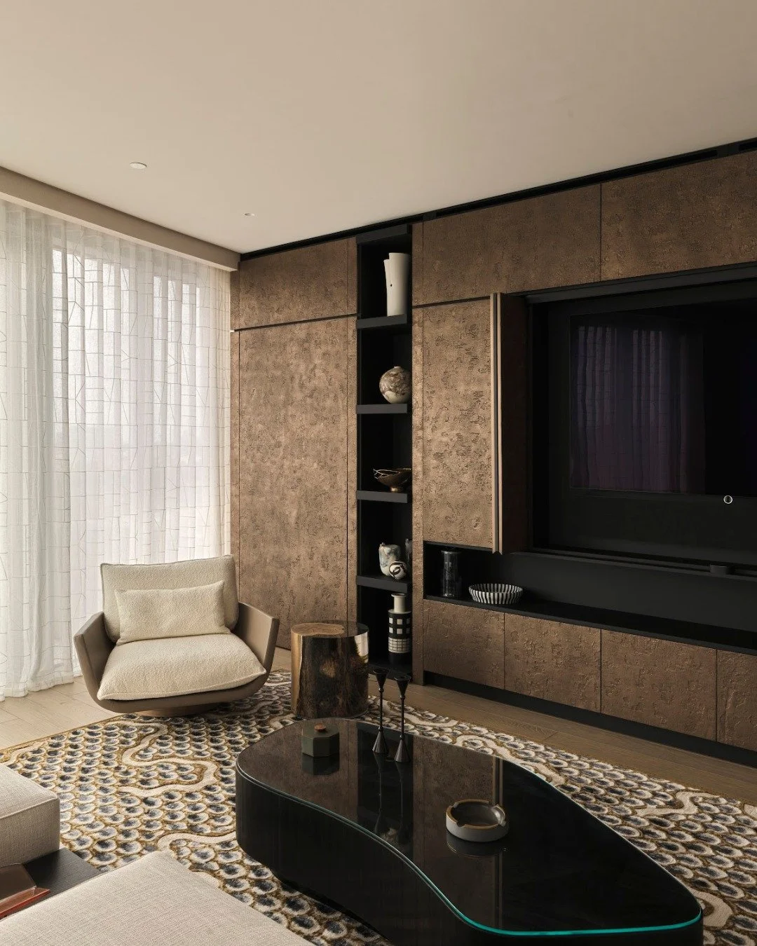 This media wall sits comfortably within this room, with bi-fold pocket doors allowing the TV to be tucked away when it&rsquo;s not in use, helping the space stay clear and organised. W&amp;G Shou Sugi Ban bronze doors with liquid metal edges add dept