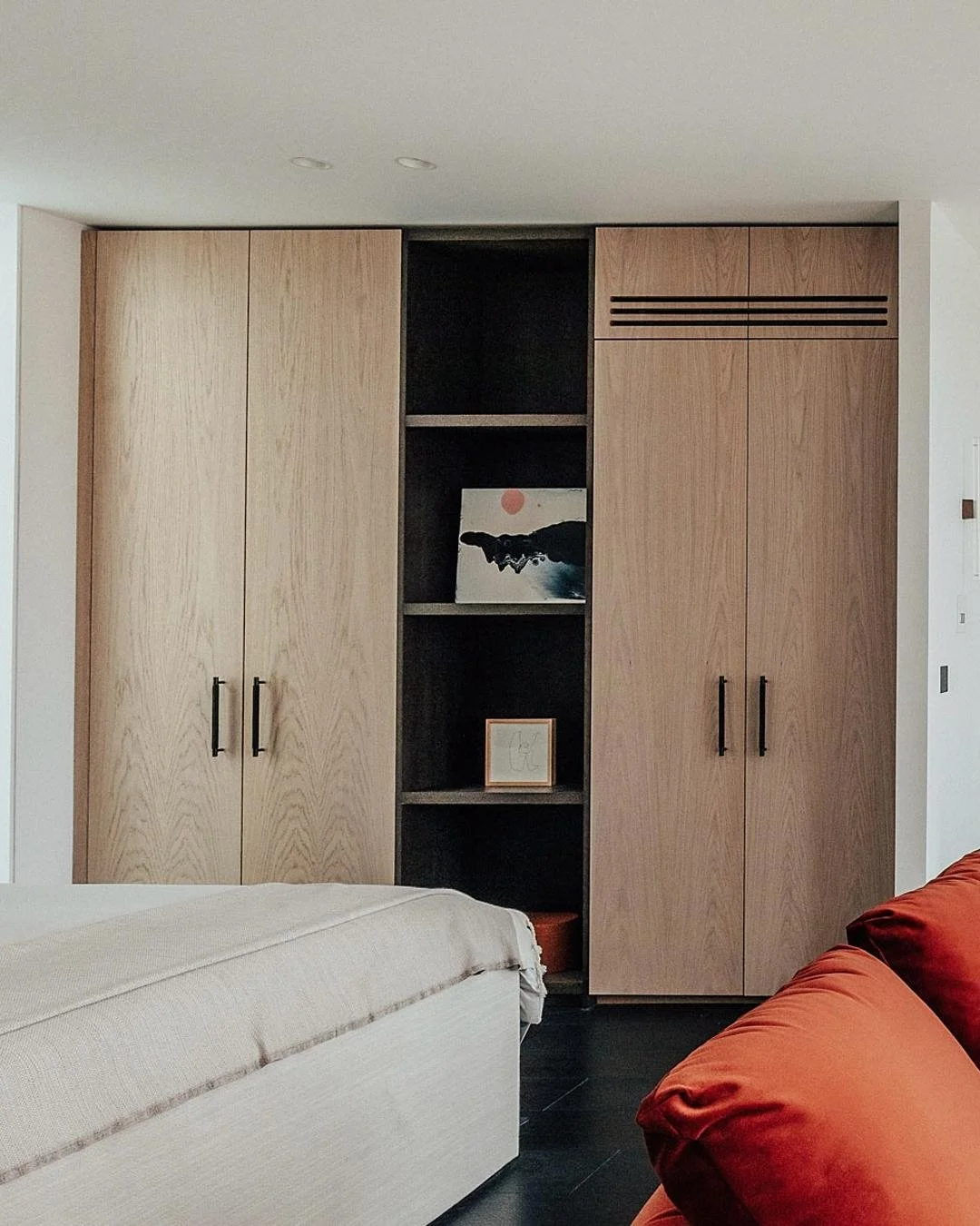 Every home expresses itself differently. One wardrobe leans into a softer, more natural feel, with crown-cut oak surfaces letting the material do the talking. The other brings in contrast through our W&amp;G Cracked metallic panels in a bronze finish