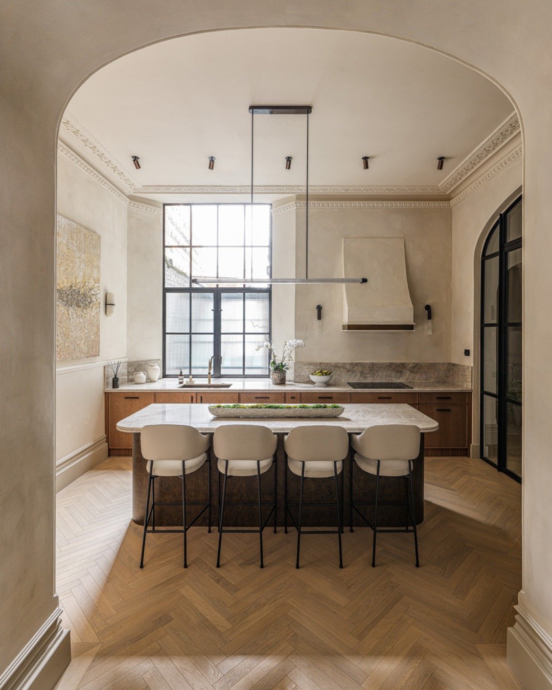 Designed for a client who wanted a refined, welcoming home for when family visited from the US, this kitchen was created to feel warm, lived-in, and comfortable - a space that naturally invites people to spend time there. With the sink and hob crafte