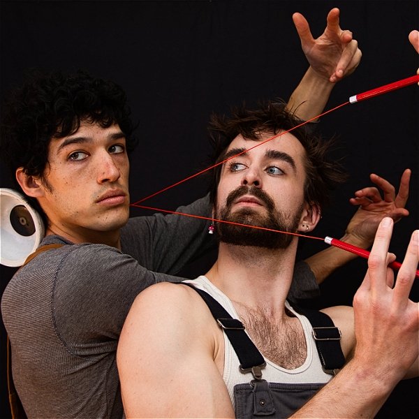 Two guys, red string: very taught on faces, overalls