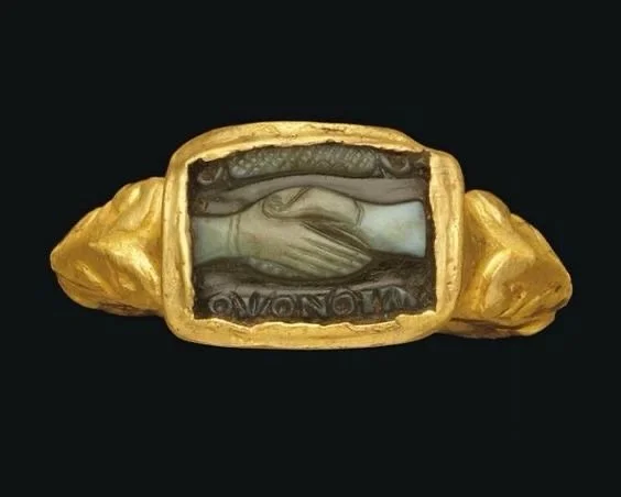 ✨🤝Even the ancient civilisations understood that jewellery marks the moments that matter most. The binding of two lives into one story.

Two hands clasped with OMONOIA - unity - carved beneath; a 5th century Roman betrothal ring that&rsquo;s nearly 