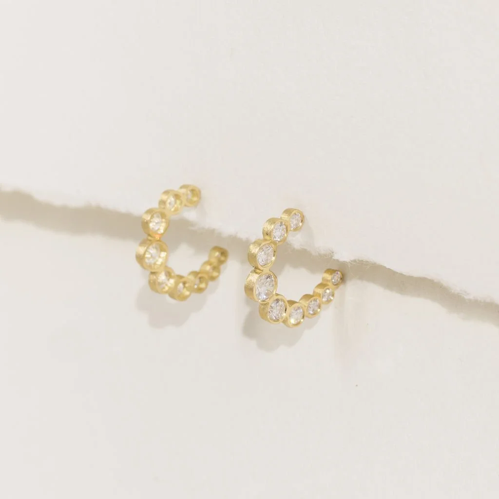 Yellow gold crescent hoop earrings set with graduated brilliant-cut lab-grown diamonds hand made by Katherine Elder