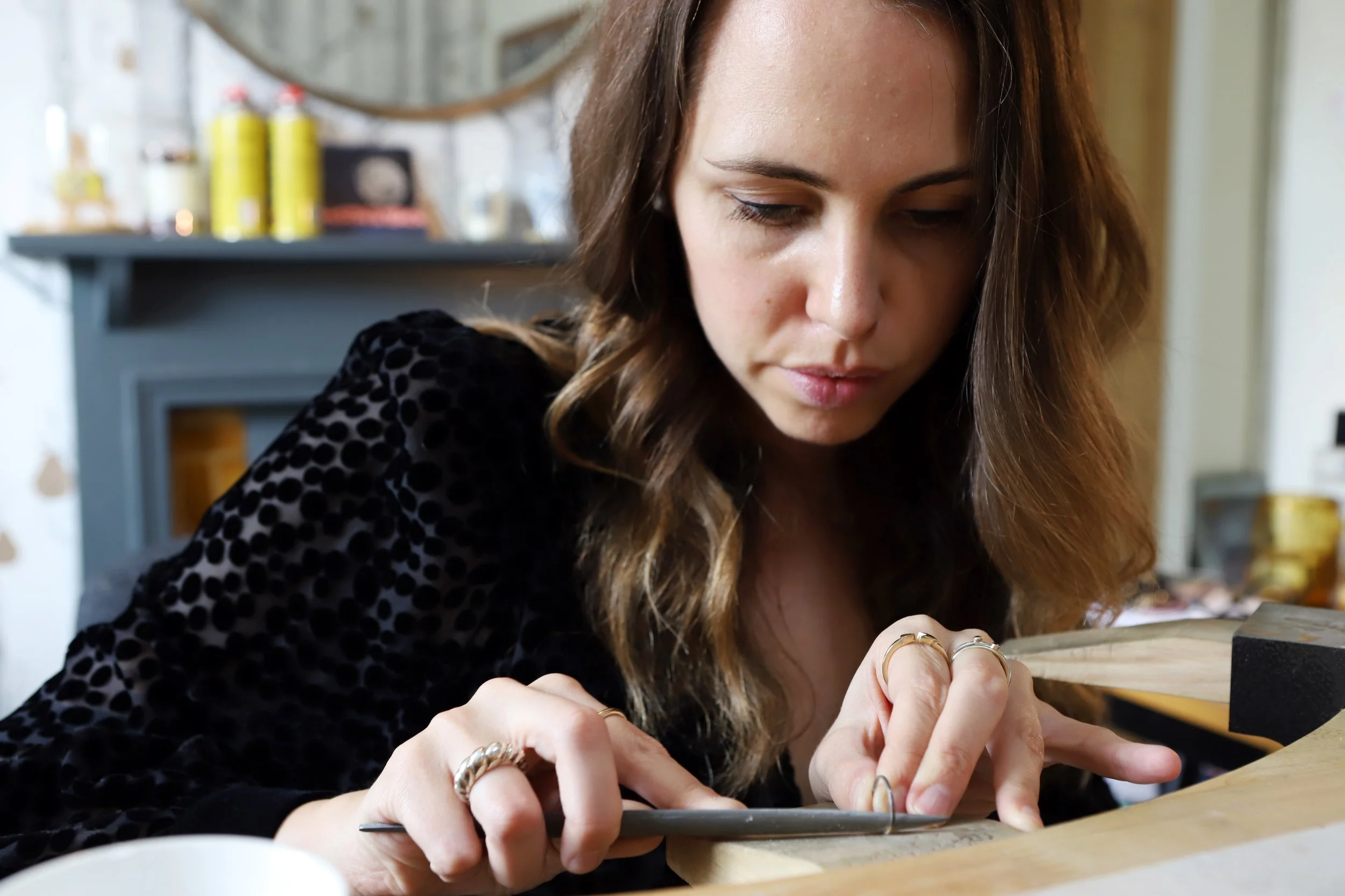 Goldsmith Katherine Elder working with gold at her North London studio bench