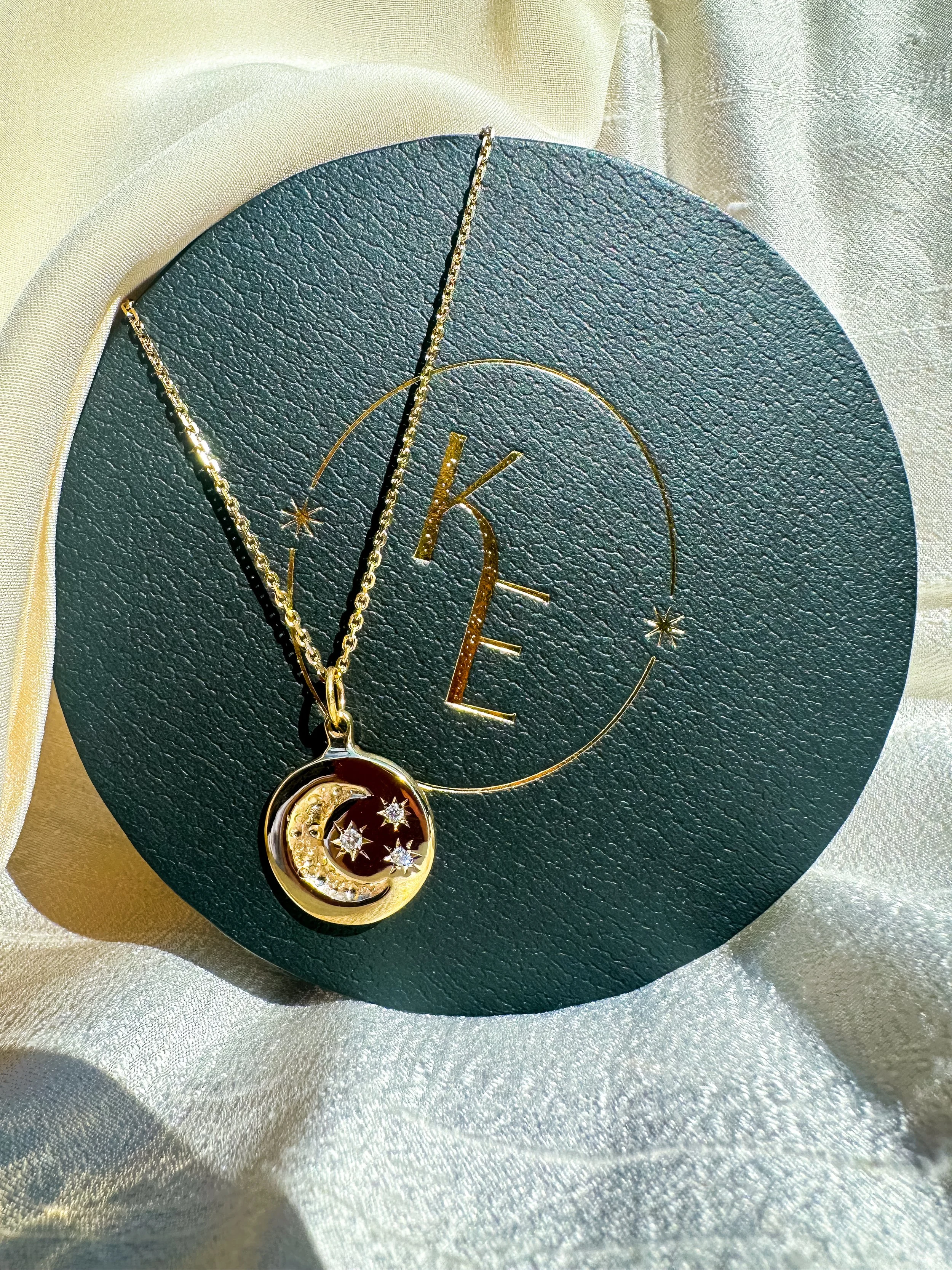 Bespoke moon and stars pendant in gold and diamonds by Katherine Elder, North London artist-goldsmith.