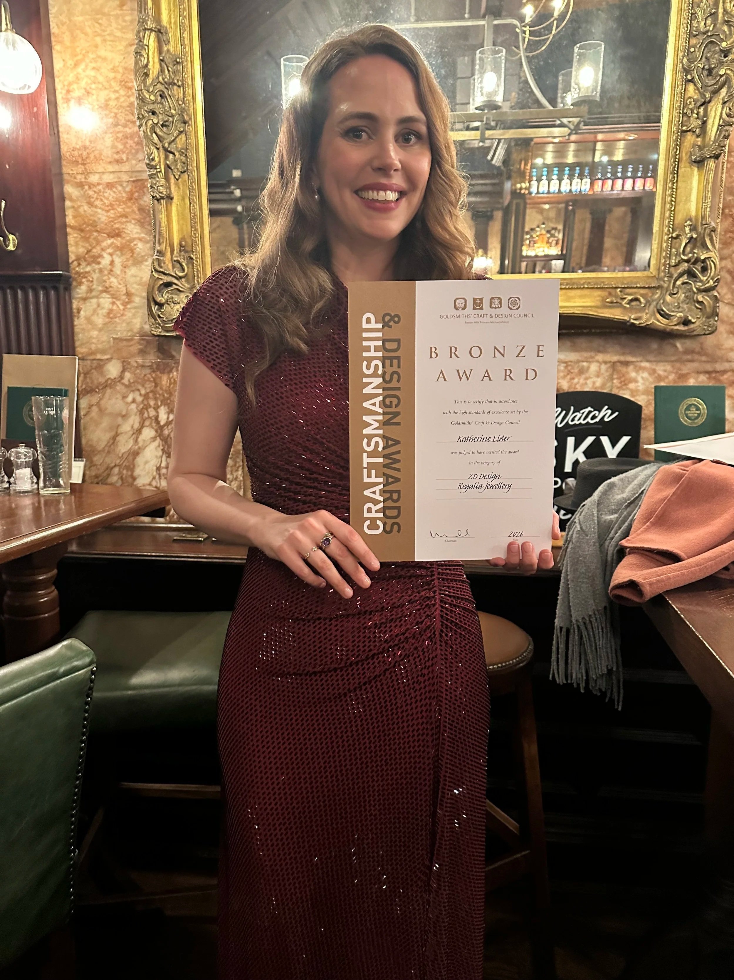 Katherine Elder receiving the GCDC 2026 Bronze Award for The Lion and the Leopard.