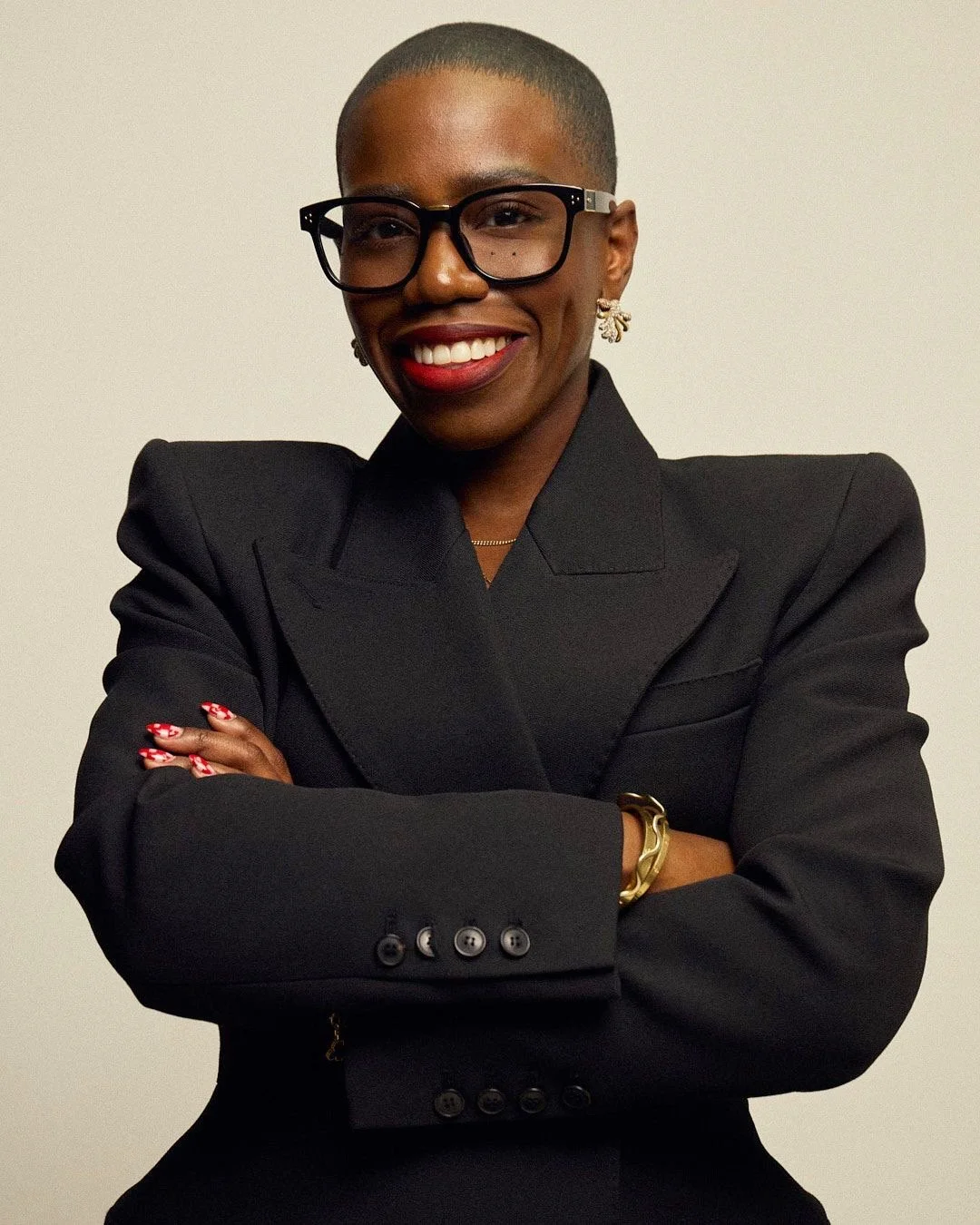 Candice Brathwaite smiling headshot wearing Linda Farrow glasses and black blazer on Corporate Speaker Page on Candice Brathwaite Corporate Speaker page on Candice Brathwaite Website