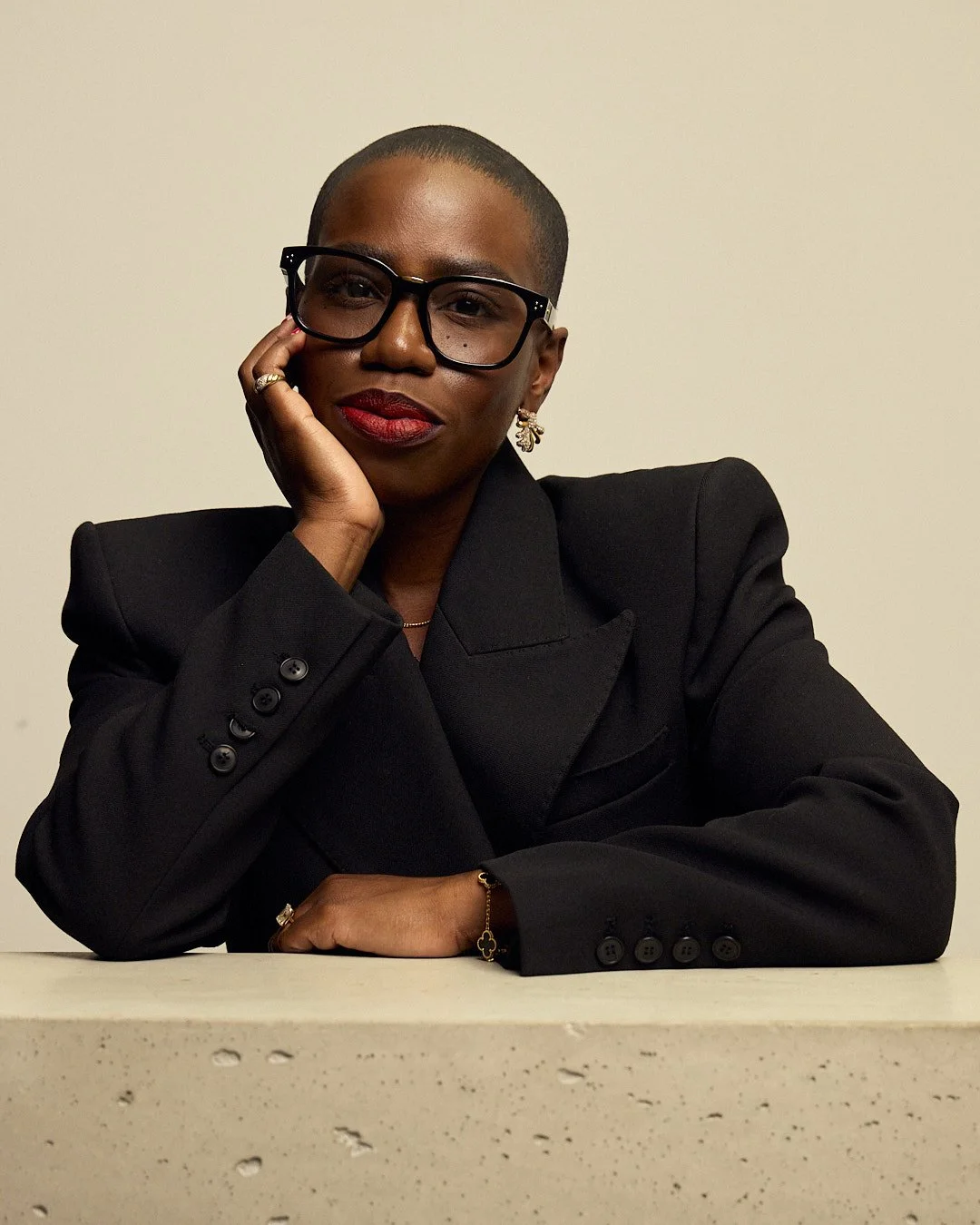 Candice Brathwaite wearing Linda Farrow frames wearing black blazer for image on candicebrathwaite.com books web page.