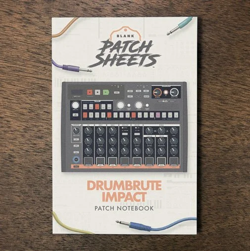 Arturia Drumbrute Impact Blank Patch Sheets Notebook on a dark wood desk