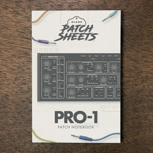 Behringer Pro-1 Blank Patch Sheets Notebook on a dark wood desk