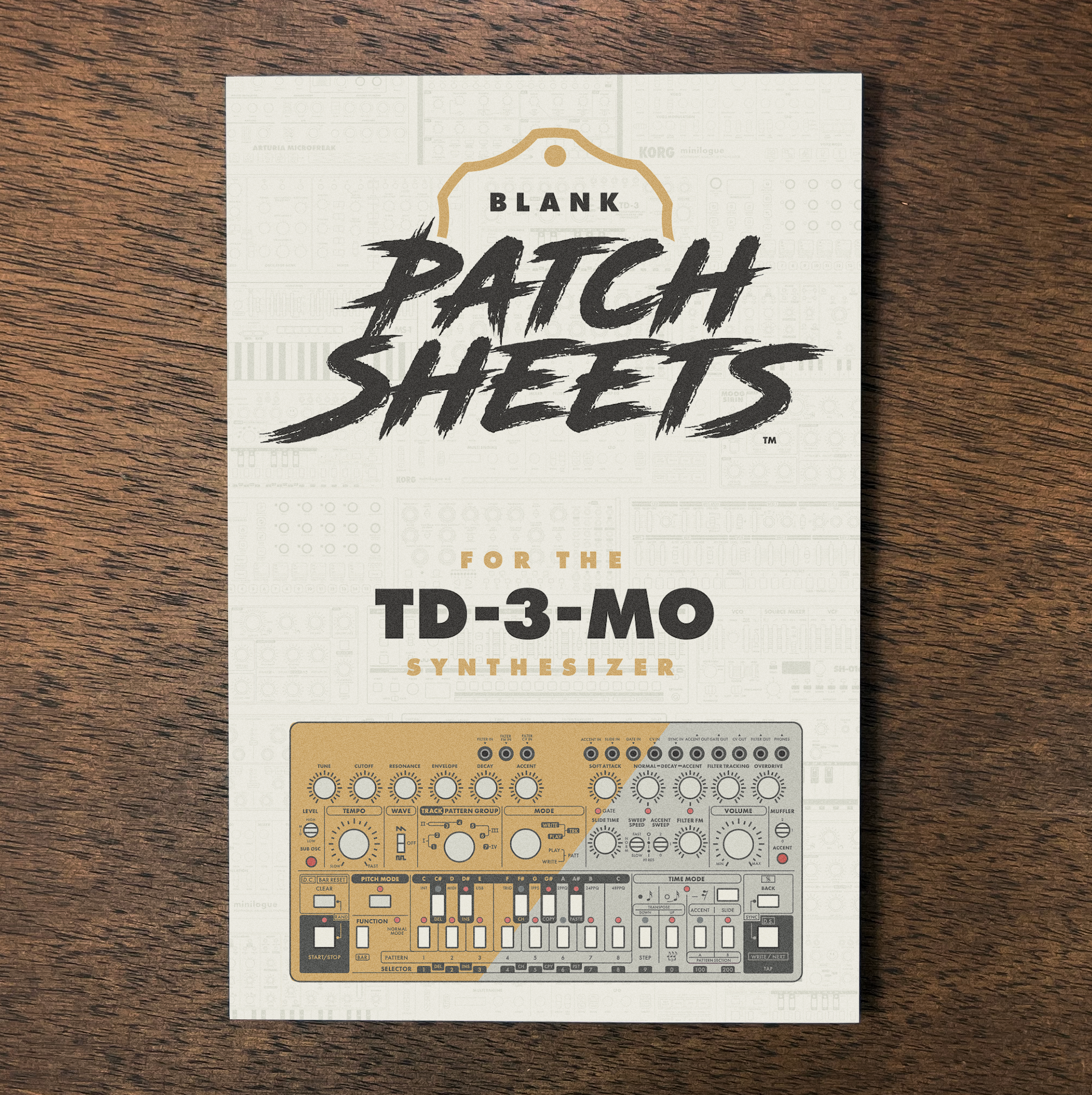 A booklet titled 'Blank Patch Sheets for the TD-3-MO Synthesizer' on a wooden surface, featuring an illustration of the synthesizer on its cover.