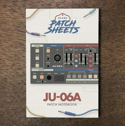 Roland JU-06a Blank Patch Sheets Notebook on a dark wood desk