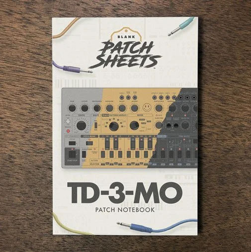 Behringer TD-3-MO Blank Patch Sheets Notebook on a dark wood desk