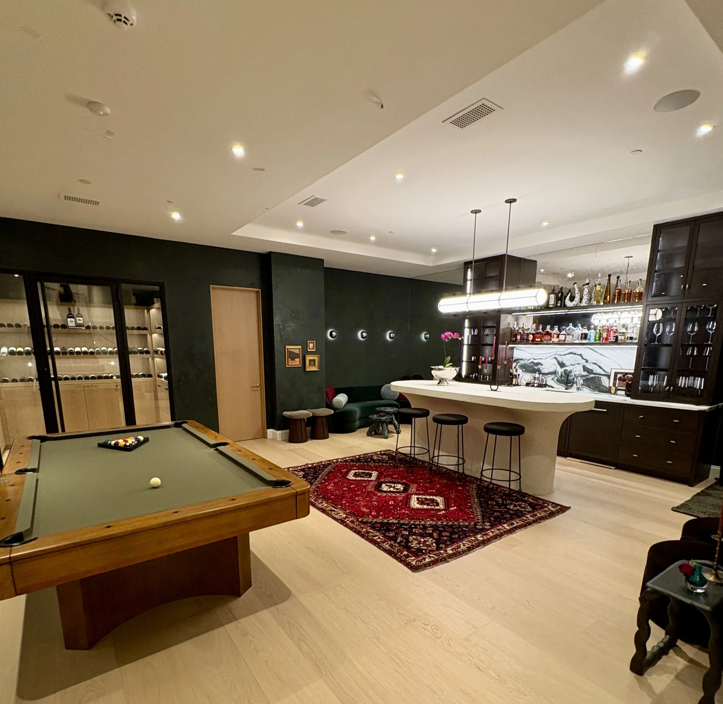 Luxury home lounge with a pool table, wine cellar, and stocked bar