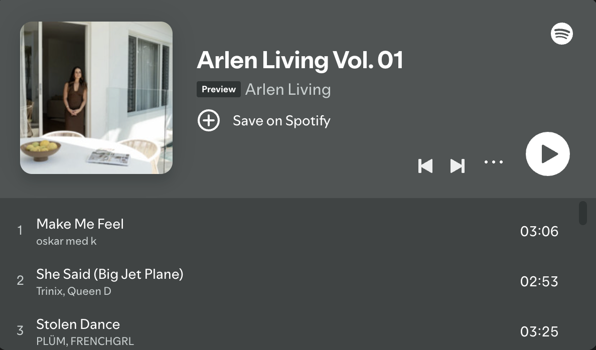 A woman standing outside a house near a sliding glass door, with a table and chairs on a patio.