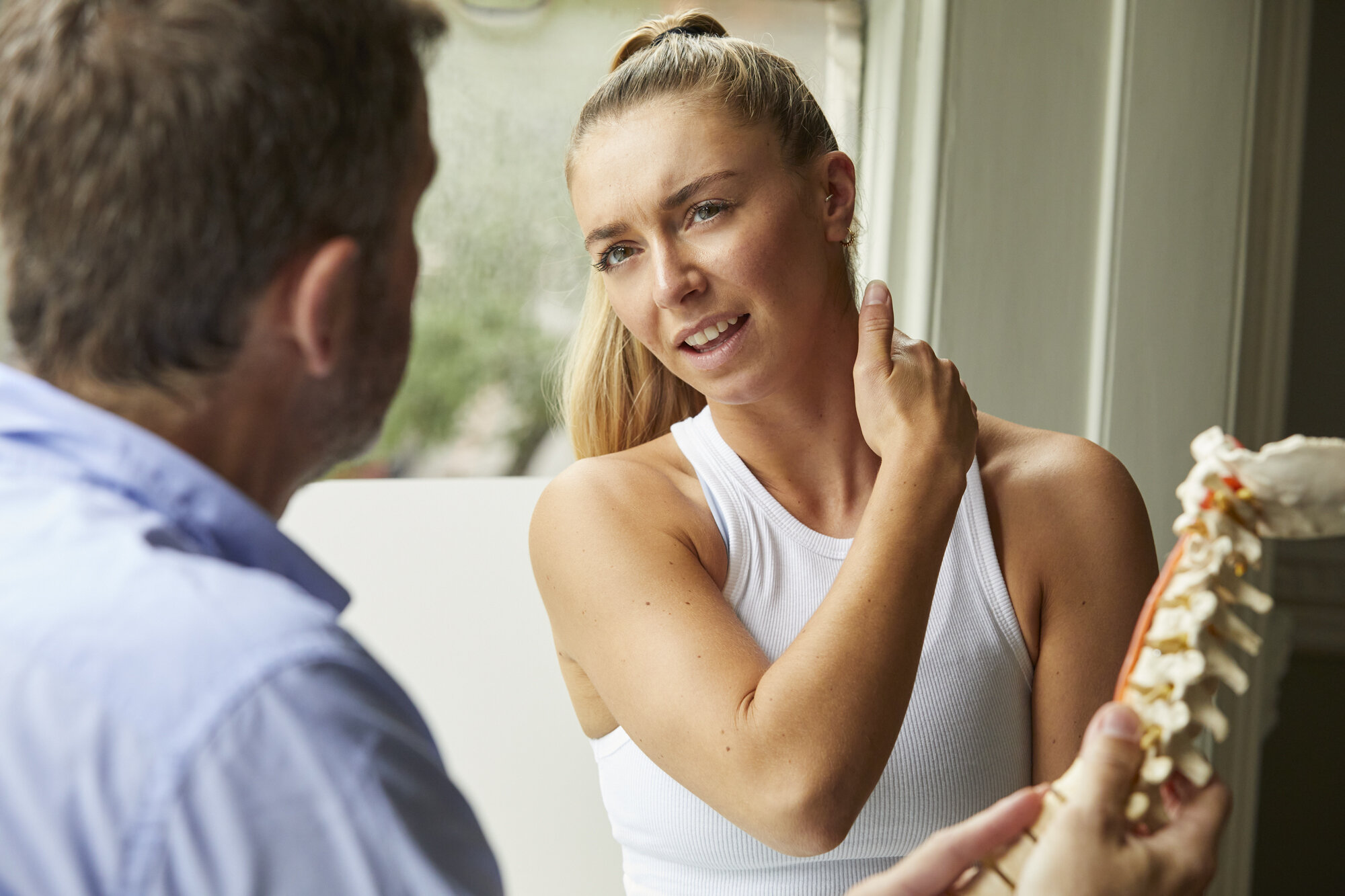 Woman experiencing neck pain at Angel Chiropractic