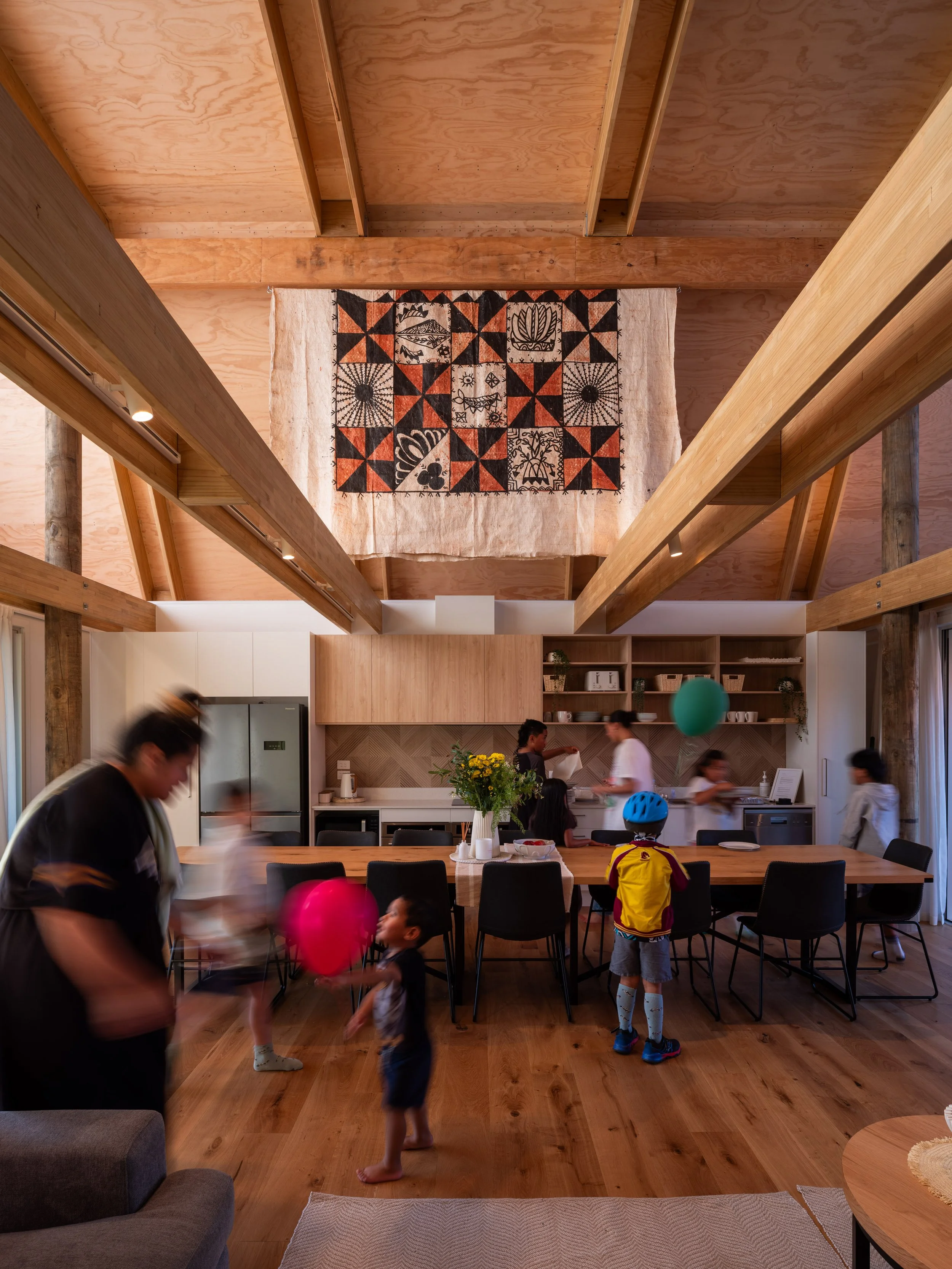 Communal space at Our Whare Our Fale in the Communal Fale, exposed timber beams and Pacifica art in Porirua