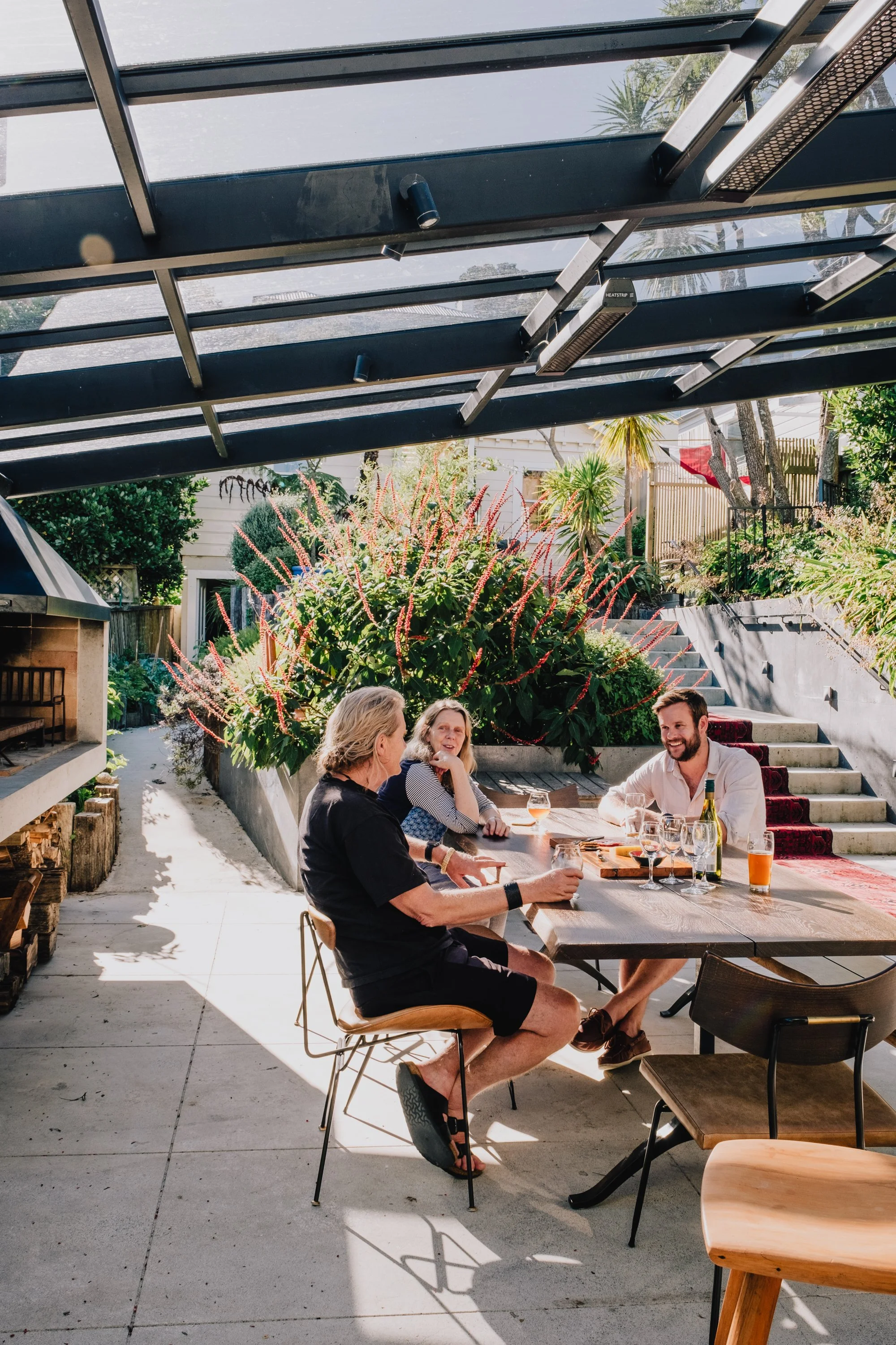Outdoor living and landscape integration at Talavera Terrace renovation in Wellington, connecting interior spaces to garden terraces and harbour views.