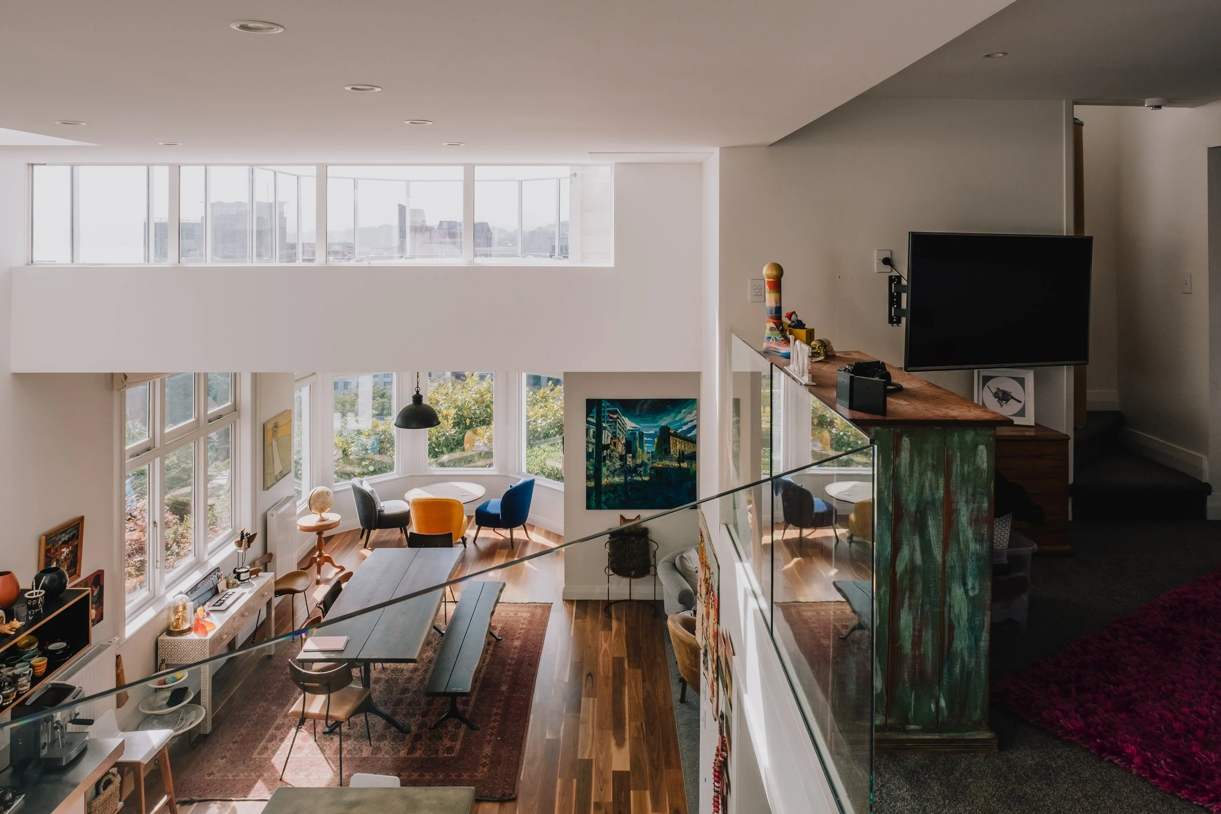 Mezzanine lounge in Wellington villa renovation at Talavera Terrace, creating a private family retreat while maintaining connection to open-plan living spaces below.