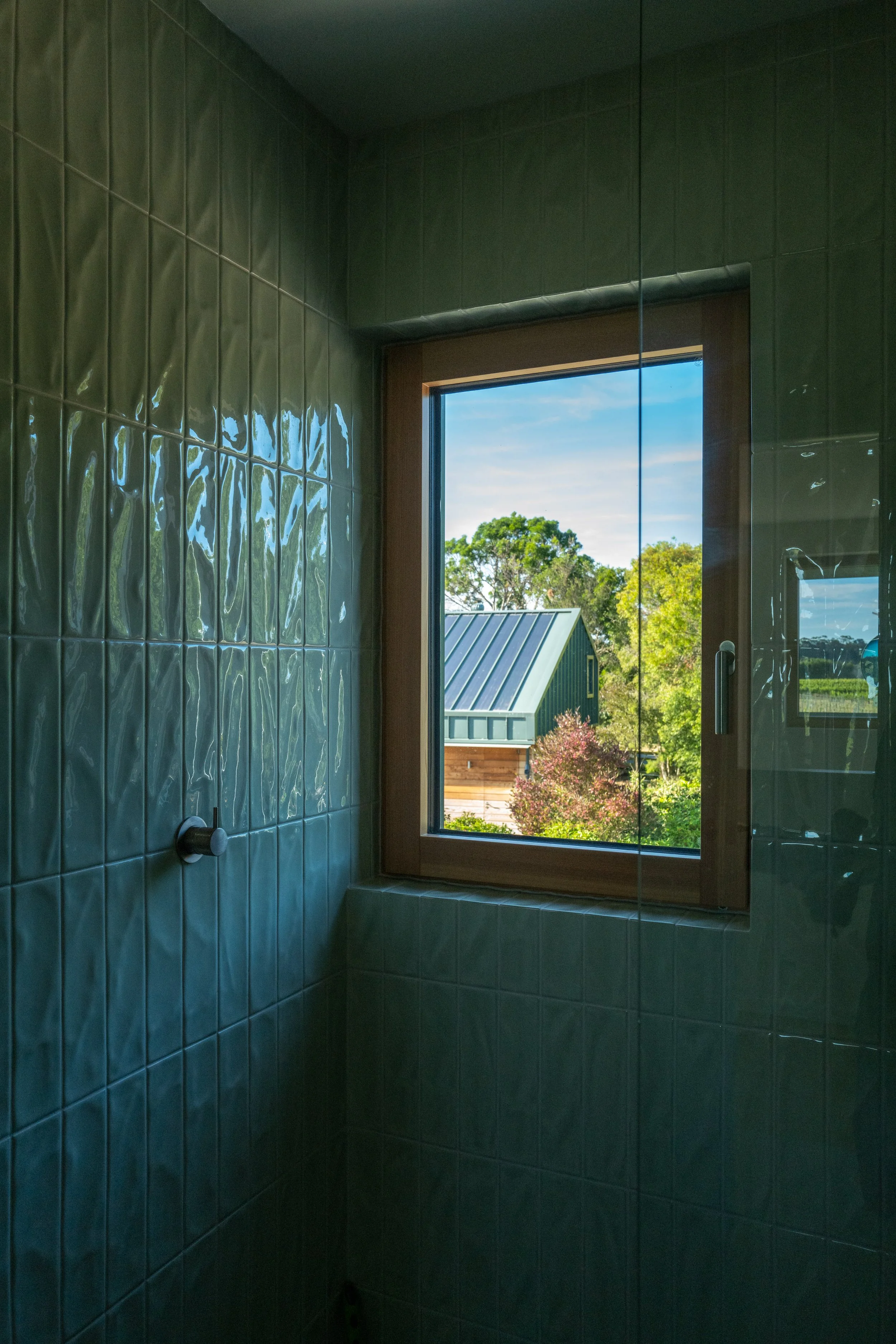 Green tiled bathroom designed by First Light Studio at Craighall