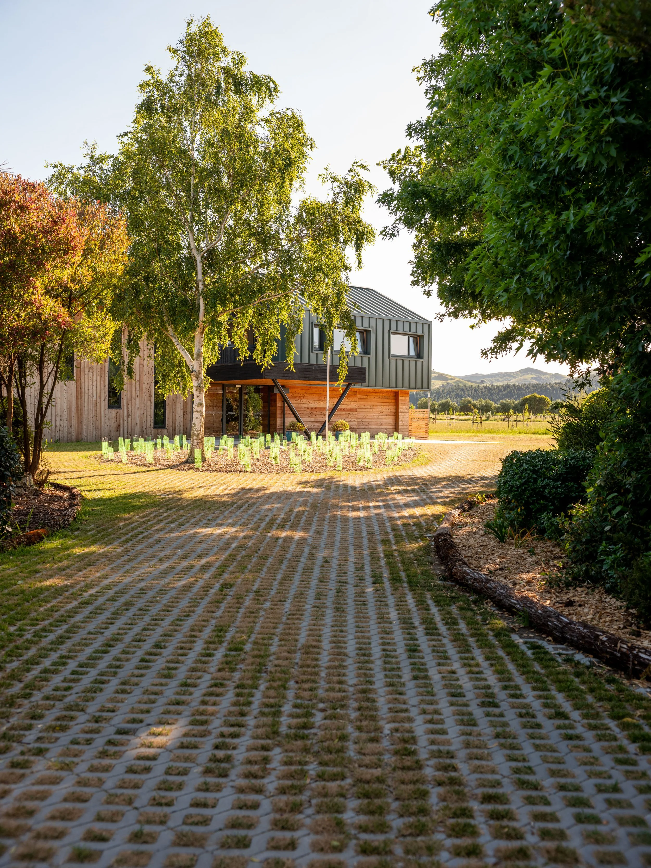 Craighall coach house by First Light Studio overlooking the rural landscape with permeable pavers for the driveway
