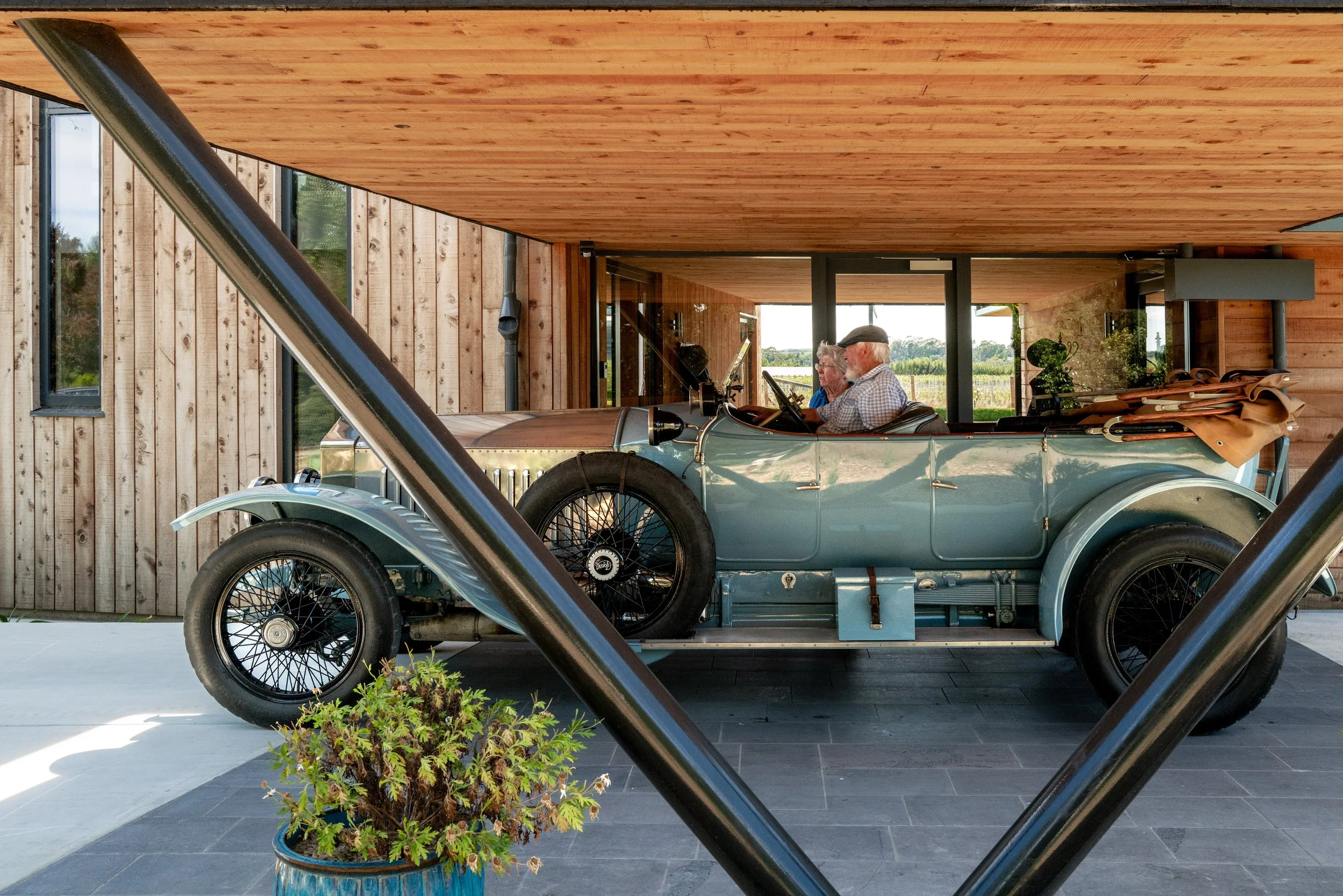 First Light Studio-designed coach house set and vintage car and carport