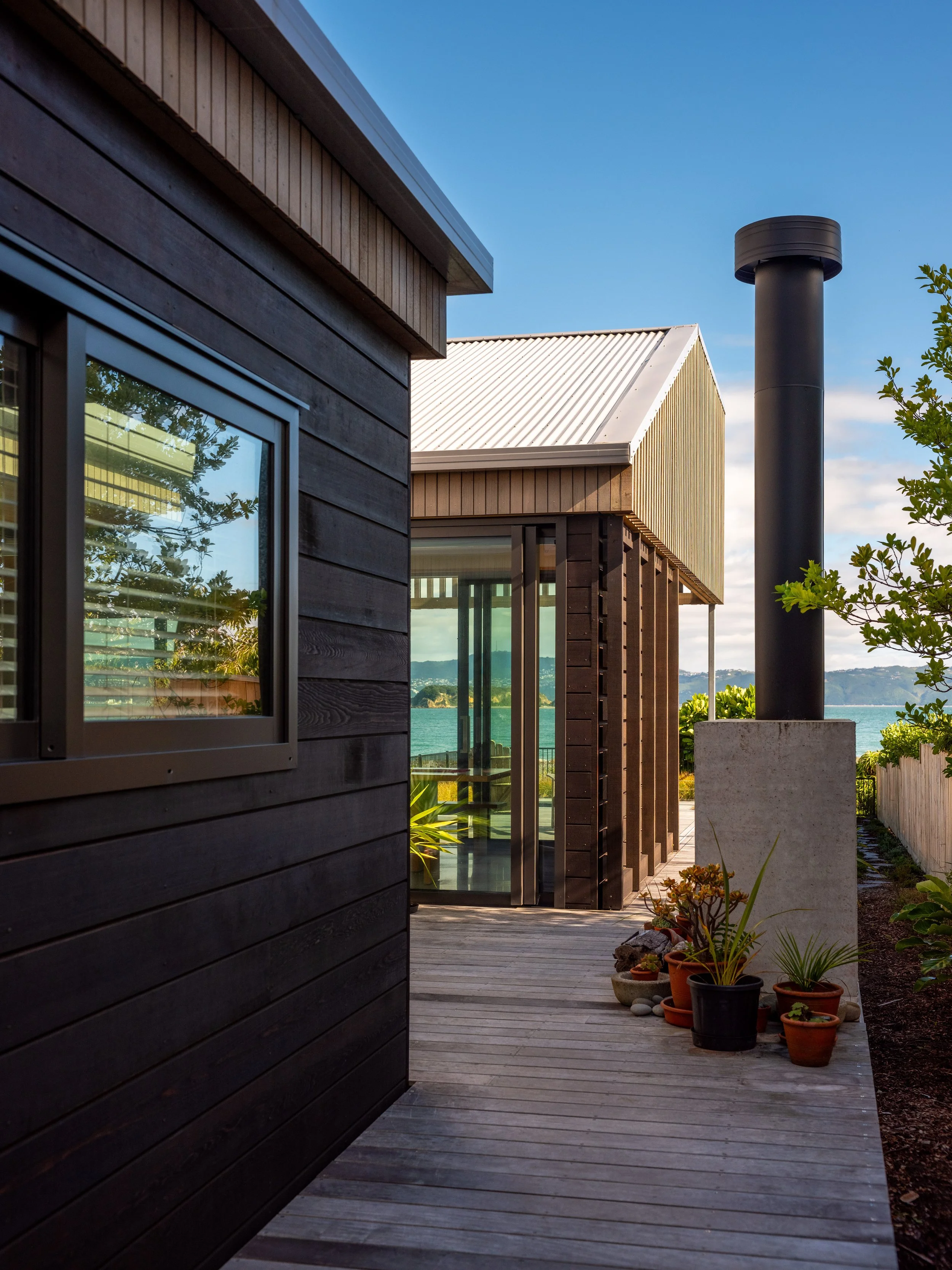 Close-up view of Eastbourne House showing timber cladding, vertical screening and the sheltered outdoor walkway.