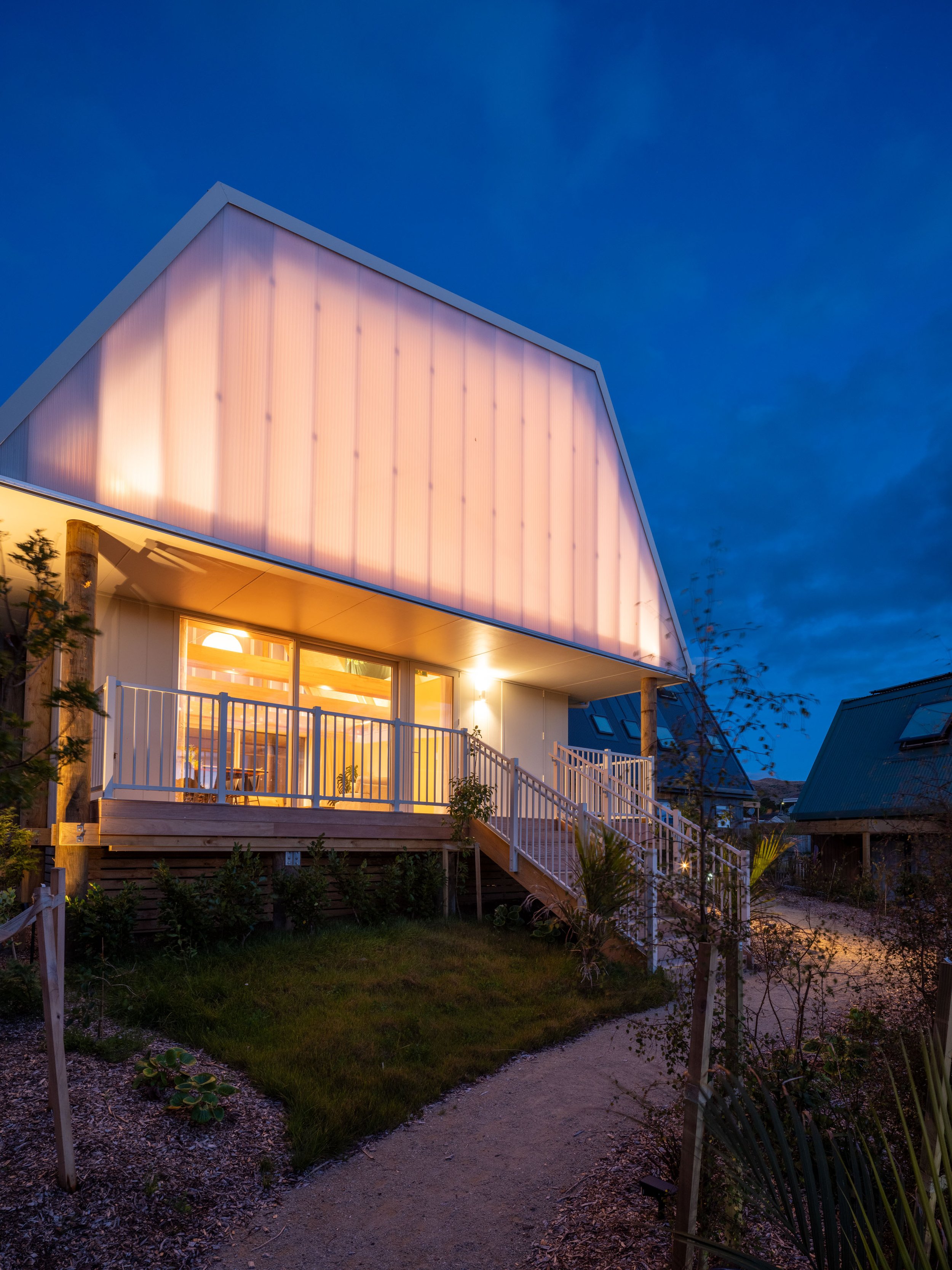 Central Communal Fale glowing at night from the malae - community garden