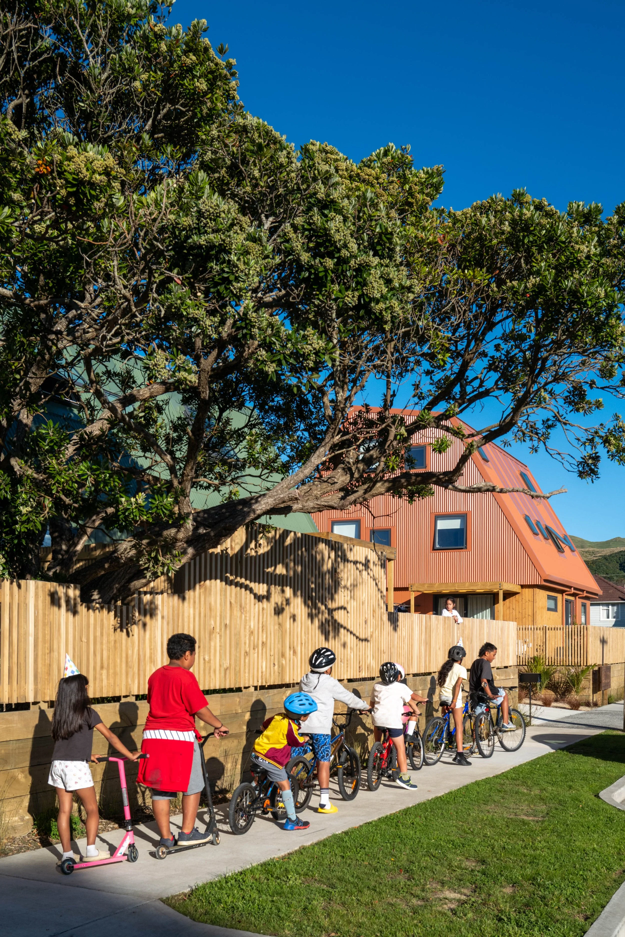 Children on bikes outside Our Whare Our Fale community housing development in Porirua