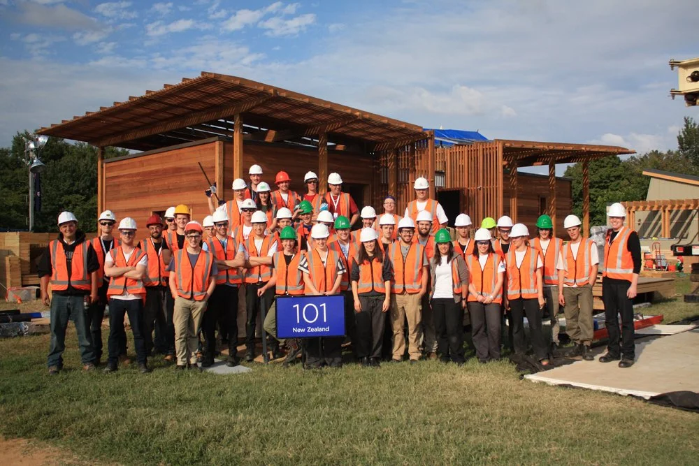 The First Light student team of Victoria University of Wellington students stand infront of their Solar Decathlon entry in Washington DC, the First Light House