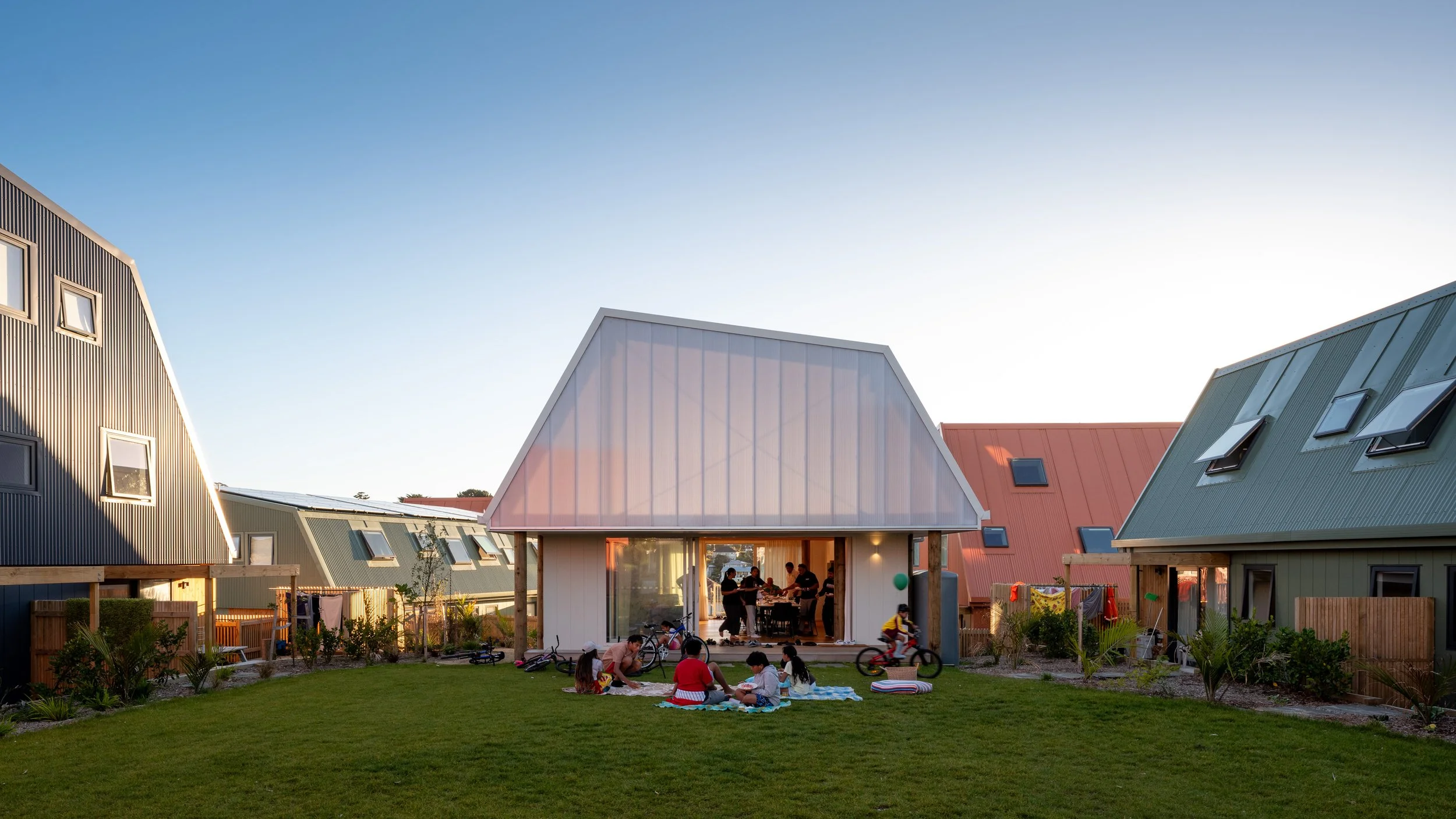 Central communal lawn and garden surrounded by homes at Our Whare Our Fale